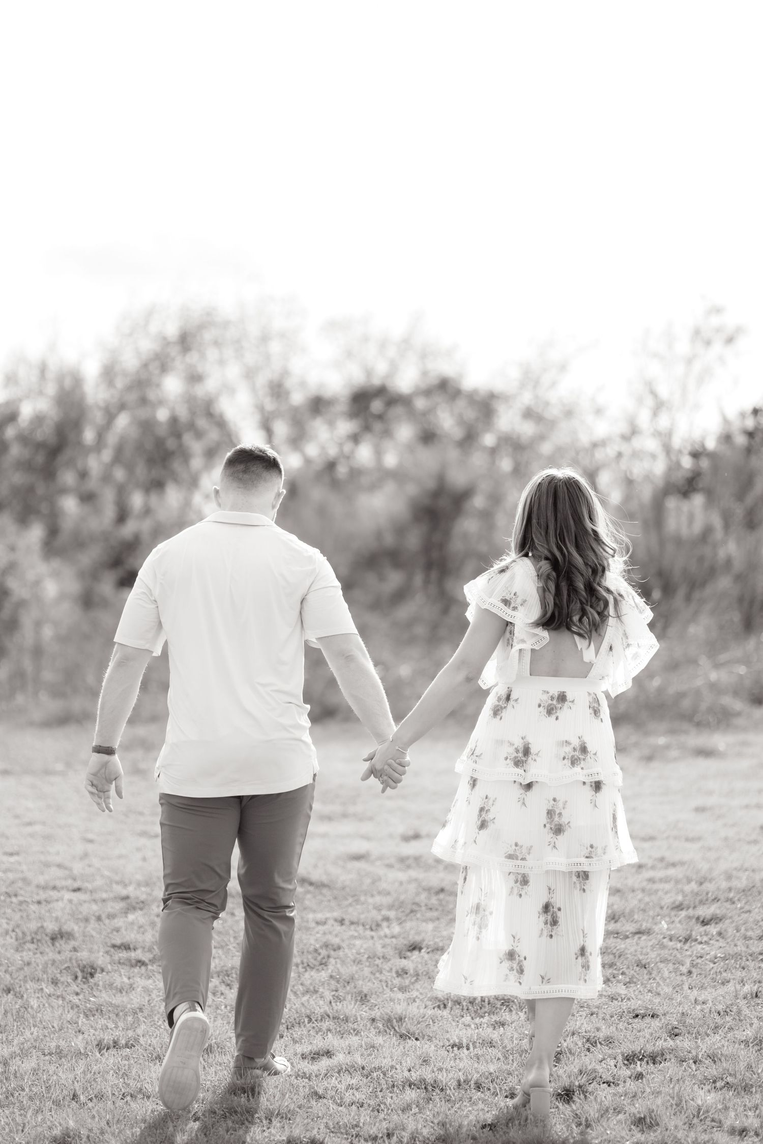 Candid image of a couple walking away together, black and white, in Dallas