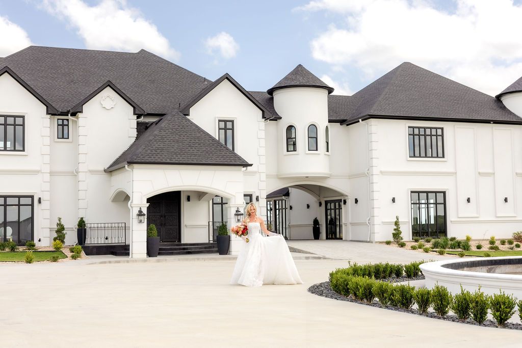 Bride walking in front of The Mansion wedding venue by Dallas wedding photographer