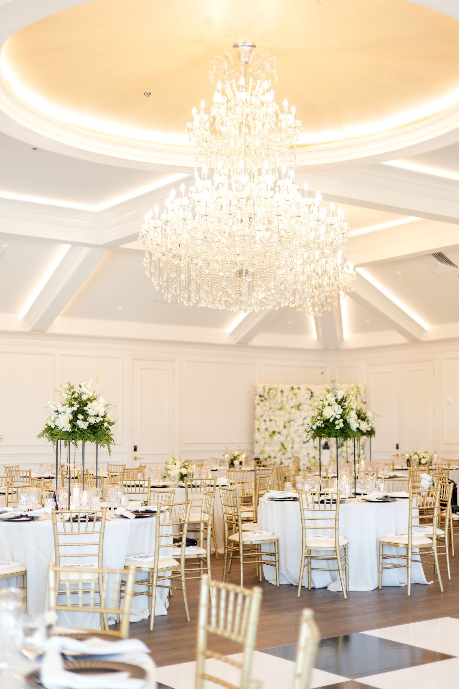 Luxury Dallas wedding reception hall with summer inspired wedding florals and a beautiful chandelier