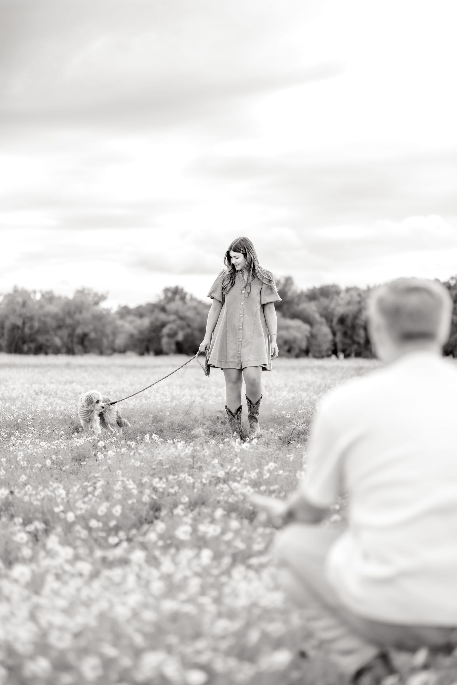 Woman walking her dog in a wildflower field in Abilene, Texas to her husband