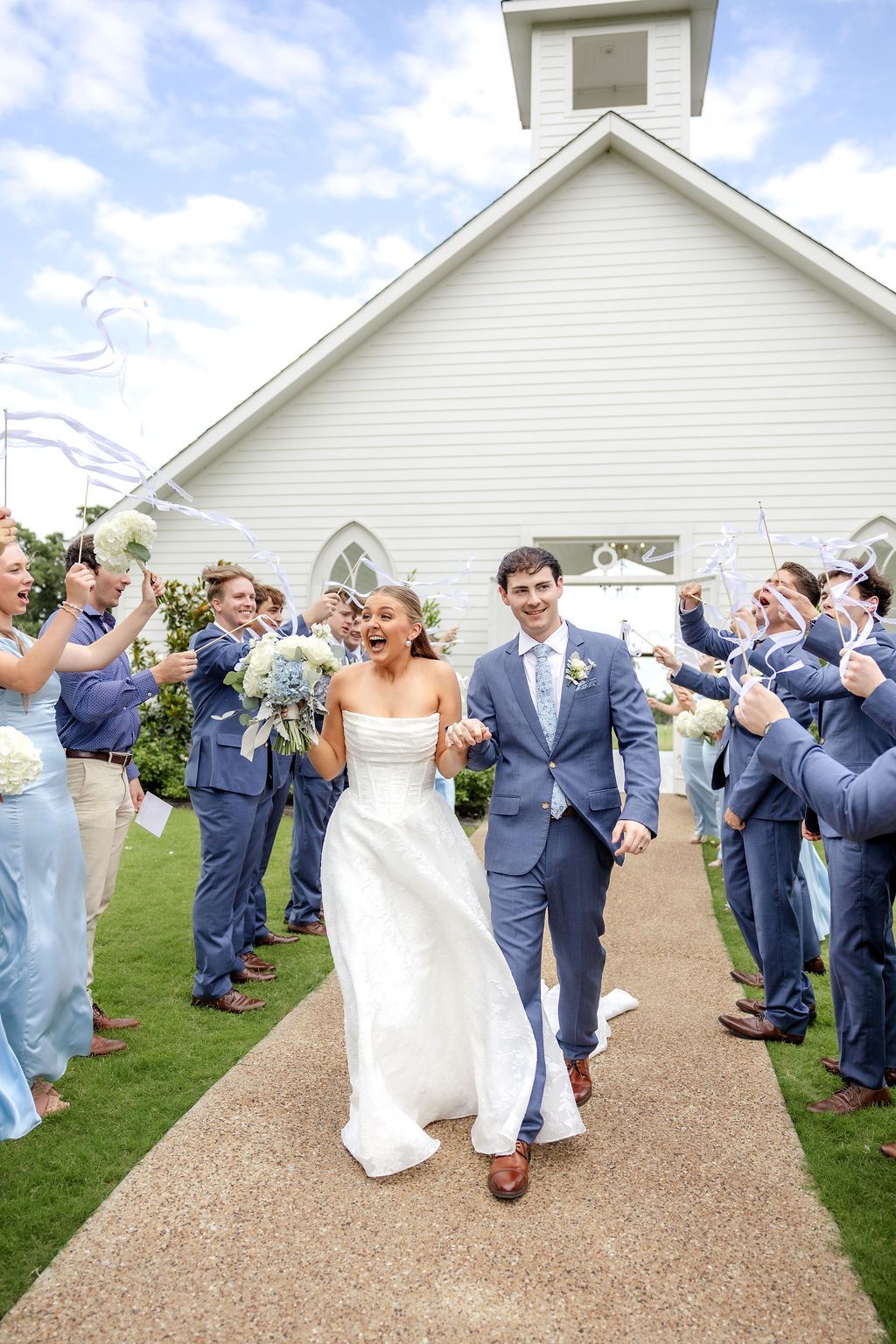 Joyful bride and groom exiting the wedding chapel after ceremony captured by a Dallas wedding photographer at Chandelier Farms