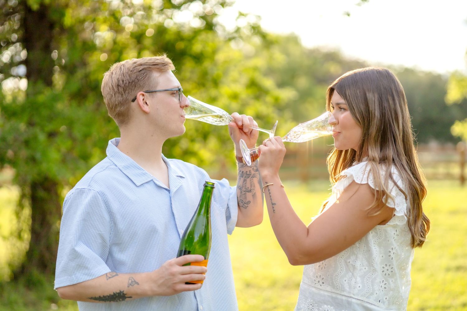 married couple sipping on champagne in a beautiful field in Abilene, Texas