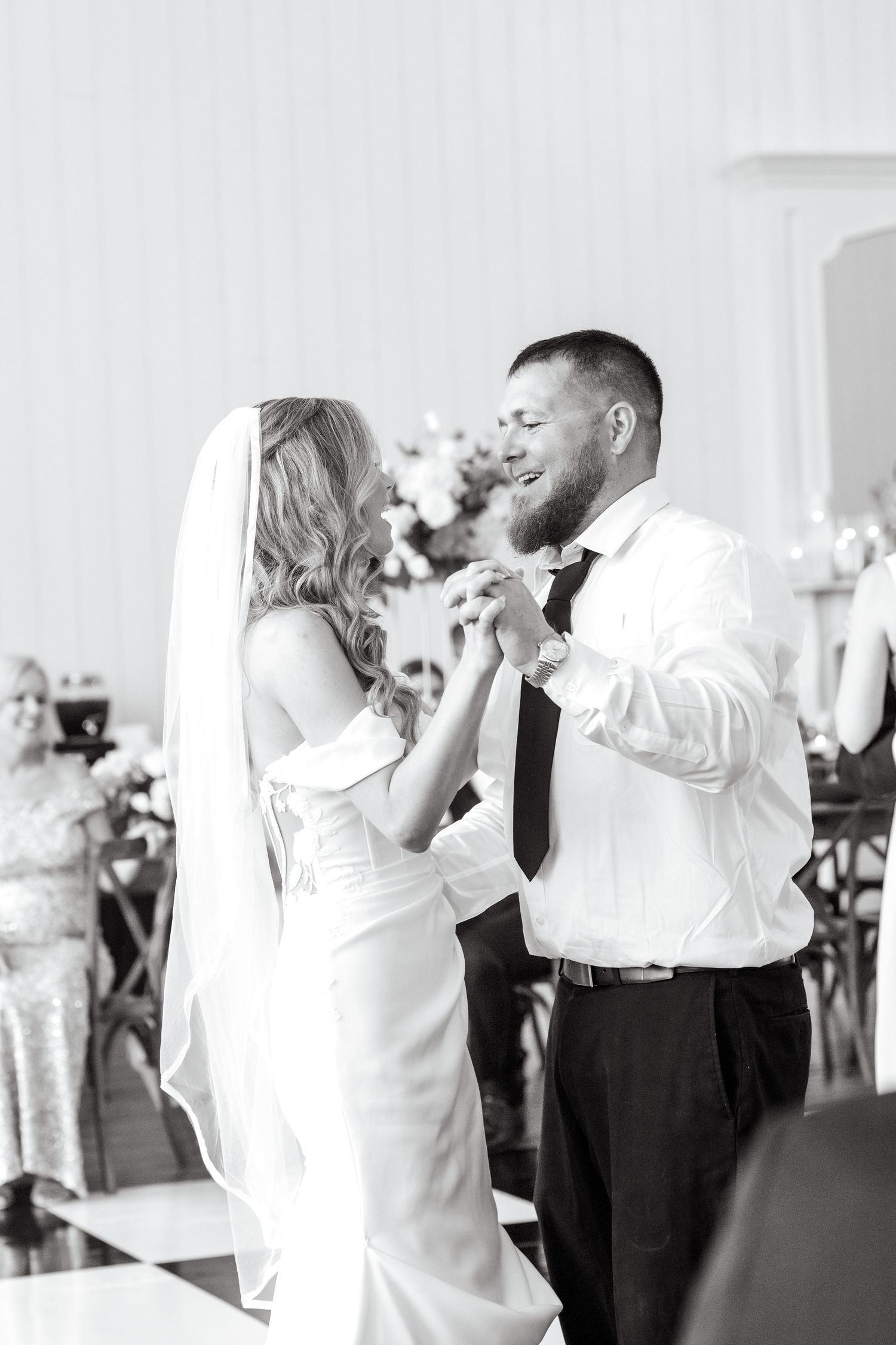 Black and white image of bride and her brother dancing together at Dallas wedding reception