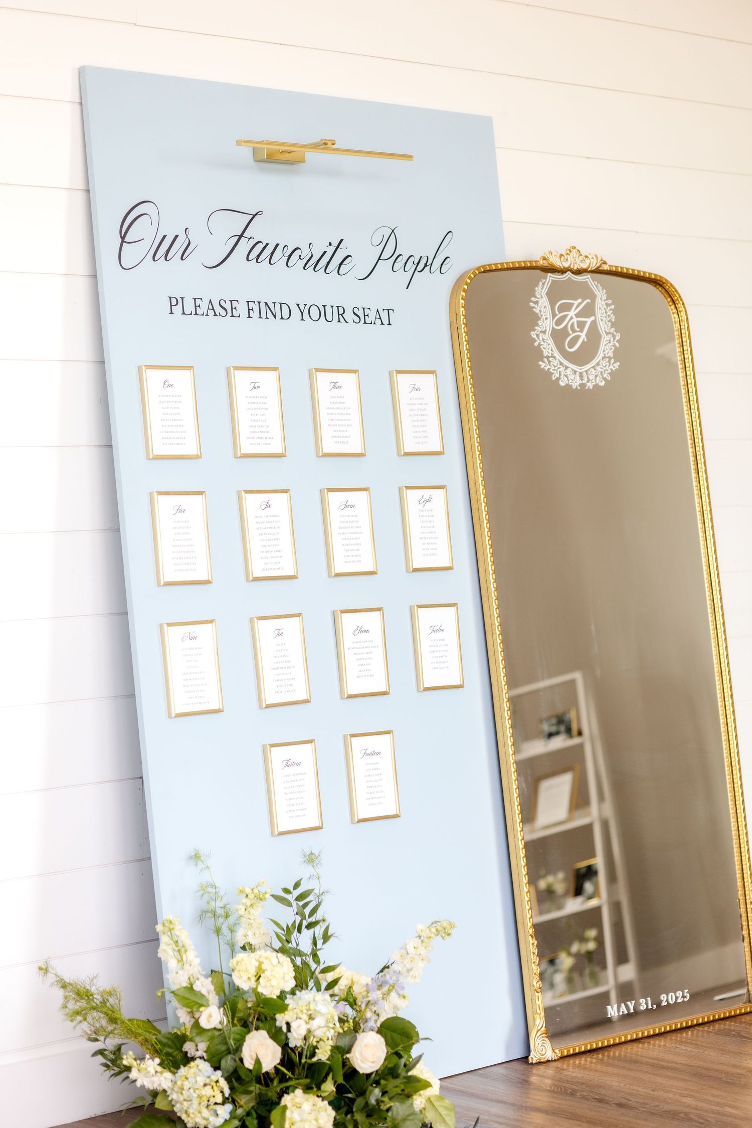 Dallas wedding reception light blue seating chart with a large gold mirror with the bride and groom's names