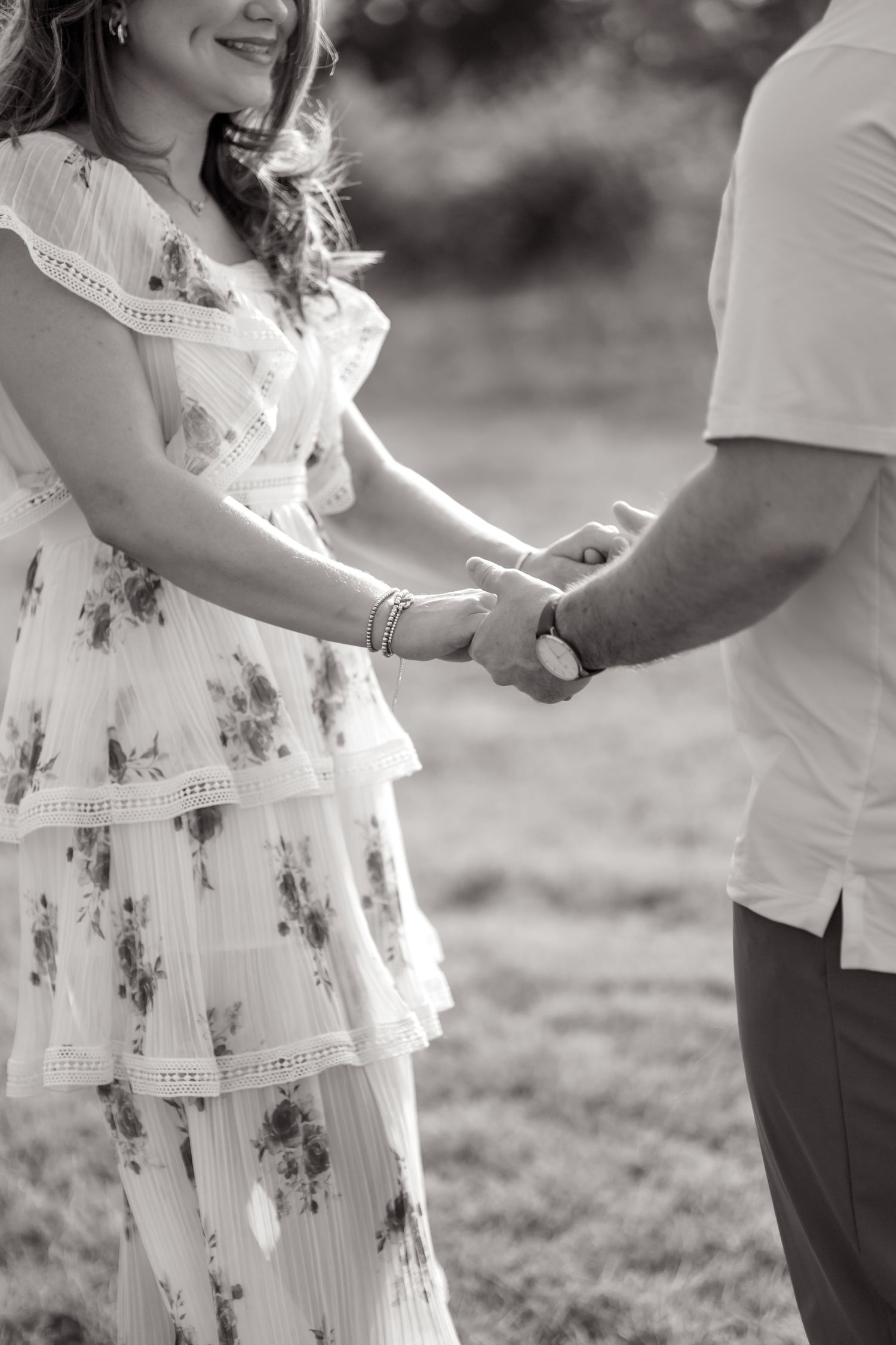 Married couple holding hands and telling each other what they love about one another at White Rock Lake photo session