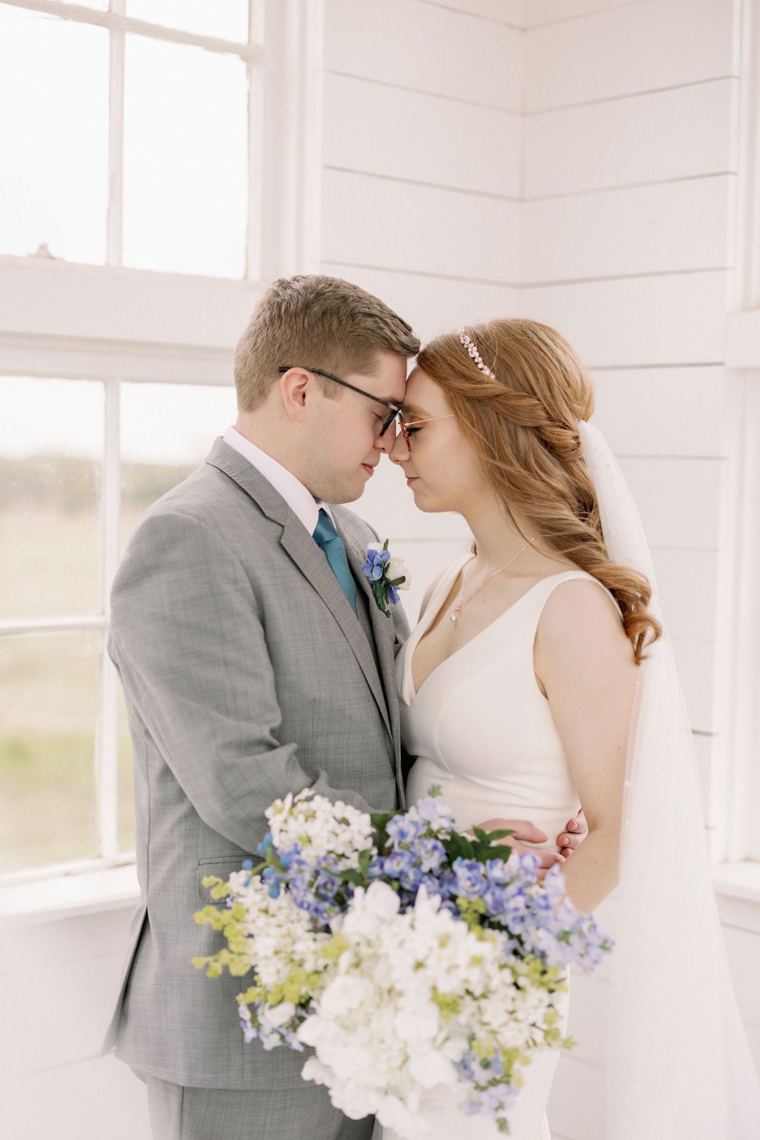 Bride and groom resting their heads together on their Spring wedding day. Dallas, Texas wedding photographer