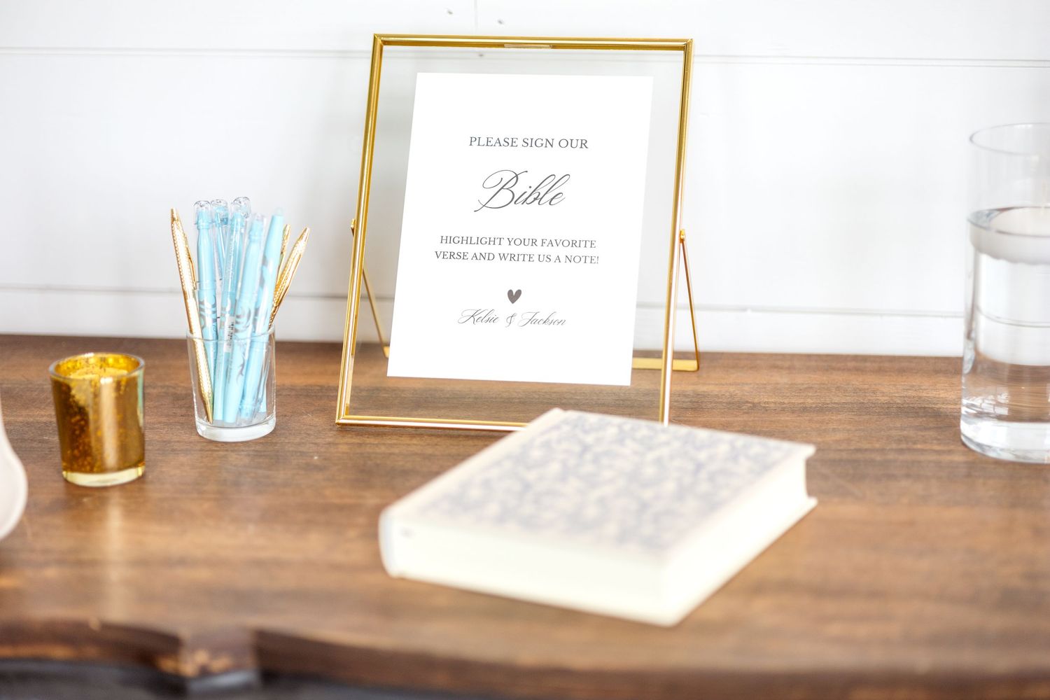 Bible guestbook with a sign asking guests to highlight their favorite verse inside the Bible sitting on the counter