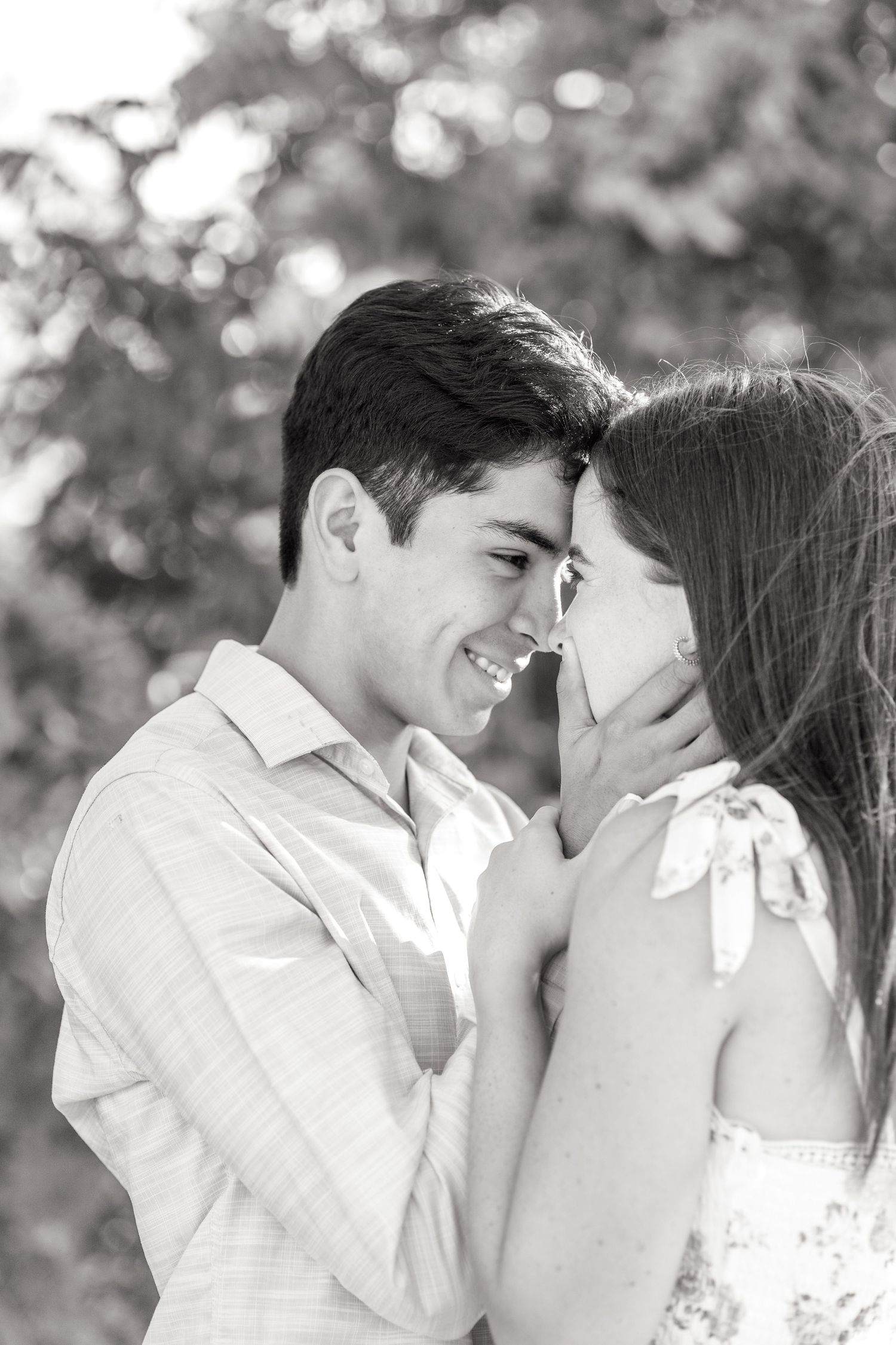 Black and white image of engaged couple nuzzling their heads together during their Dallas engagement session