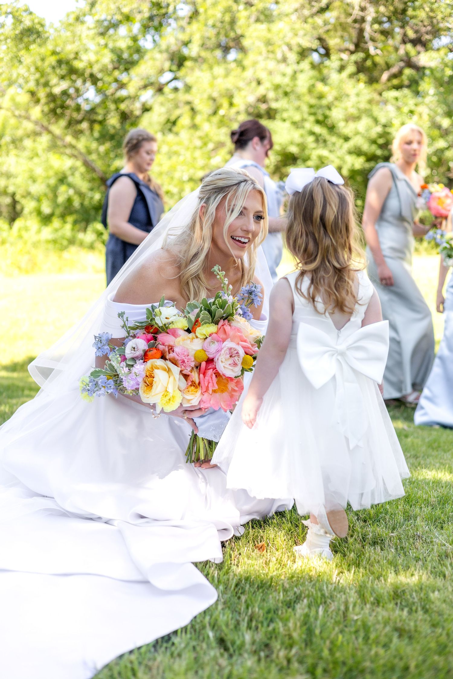 Dallas bride talking with her flower girl on wedding day