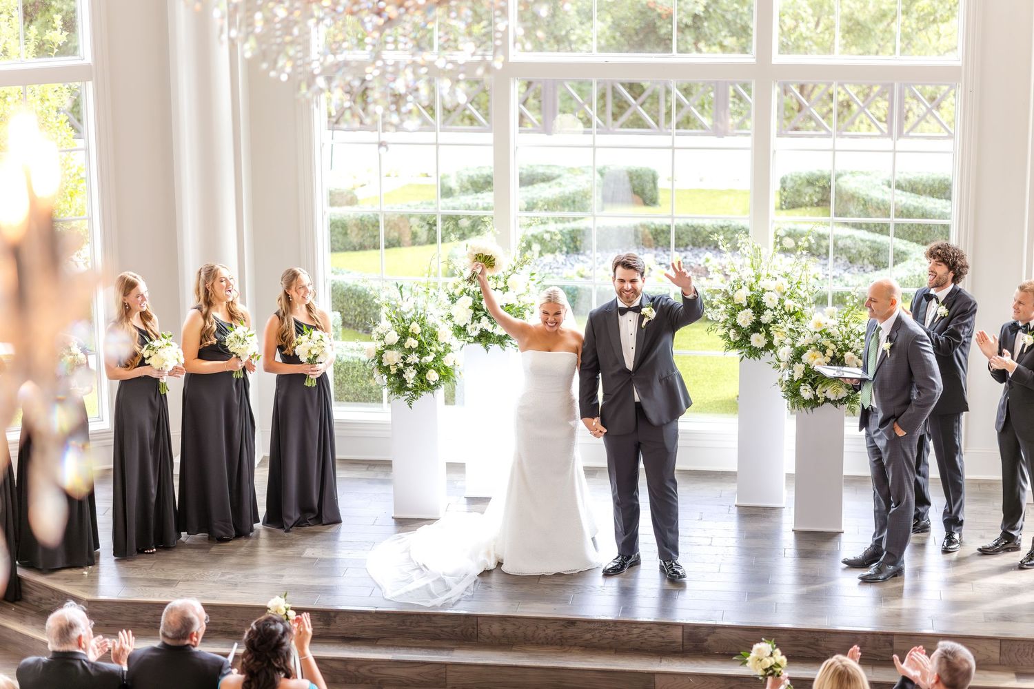 Bride and groom celebrating at end of wedding ceremony as they are announced Mr and Mrs for the first time during Dallas wedding