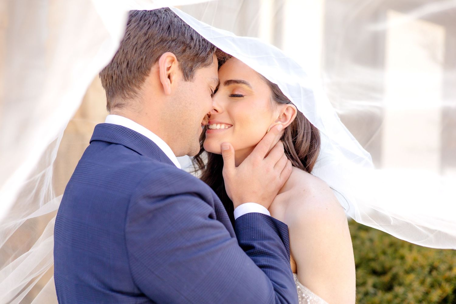 wedding veil sweeping over the bride and groom's head on the wedding day Dallas Texas wedding photographer