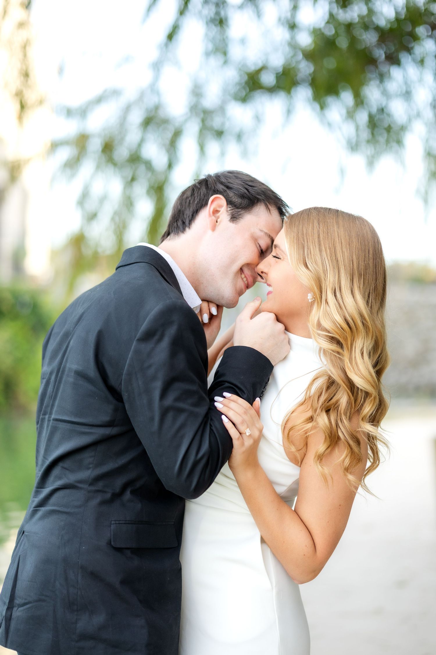 Engaged couple going in for a kiss at Dallas engagement session at Adriatica Village