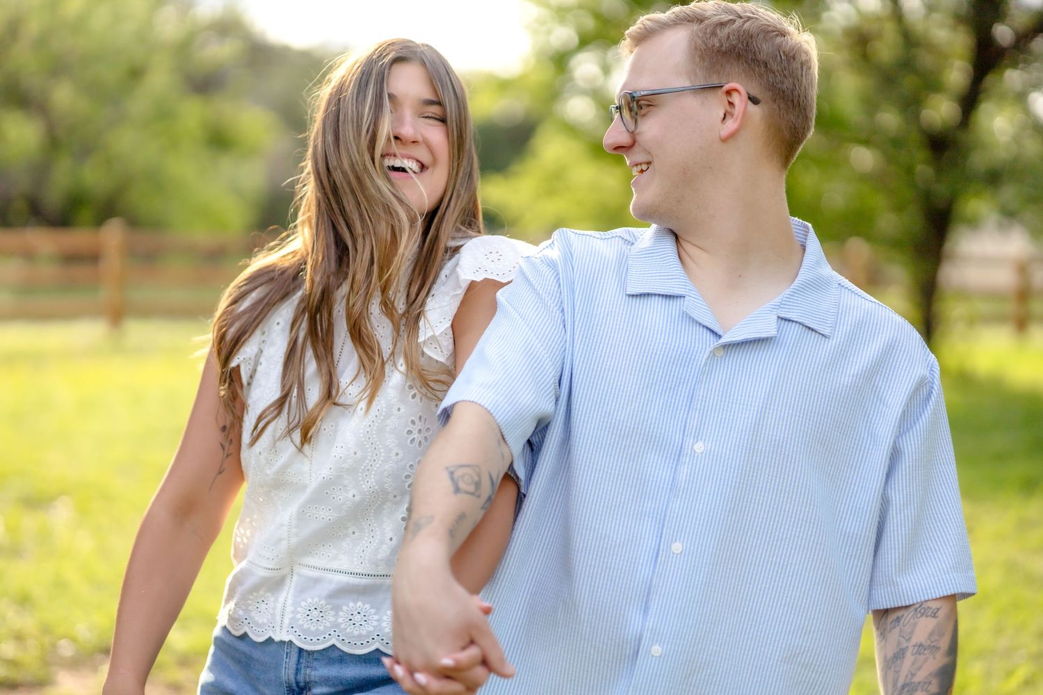 married couple walking and laughing at golden hour couple's photo session in Abilene, TX