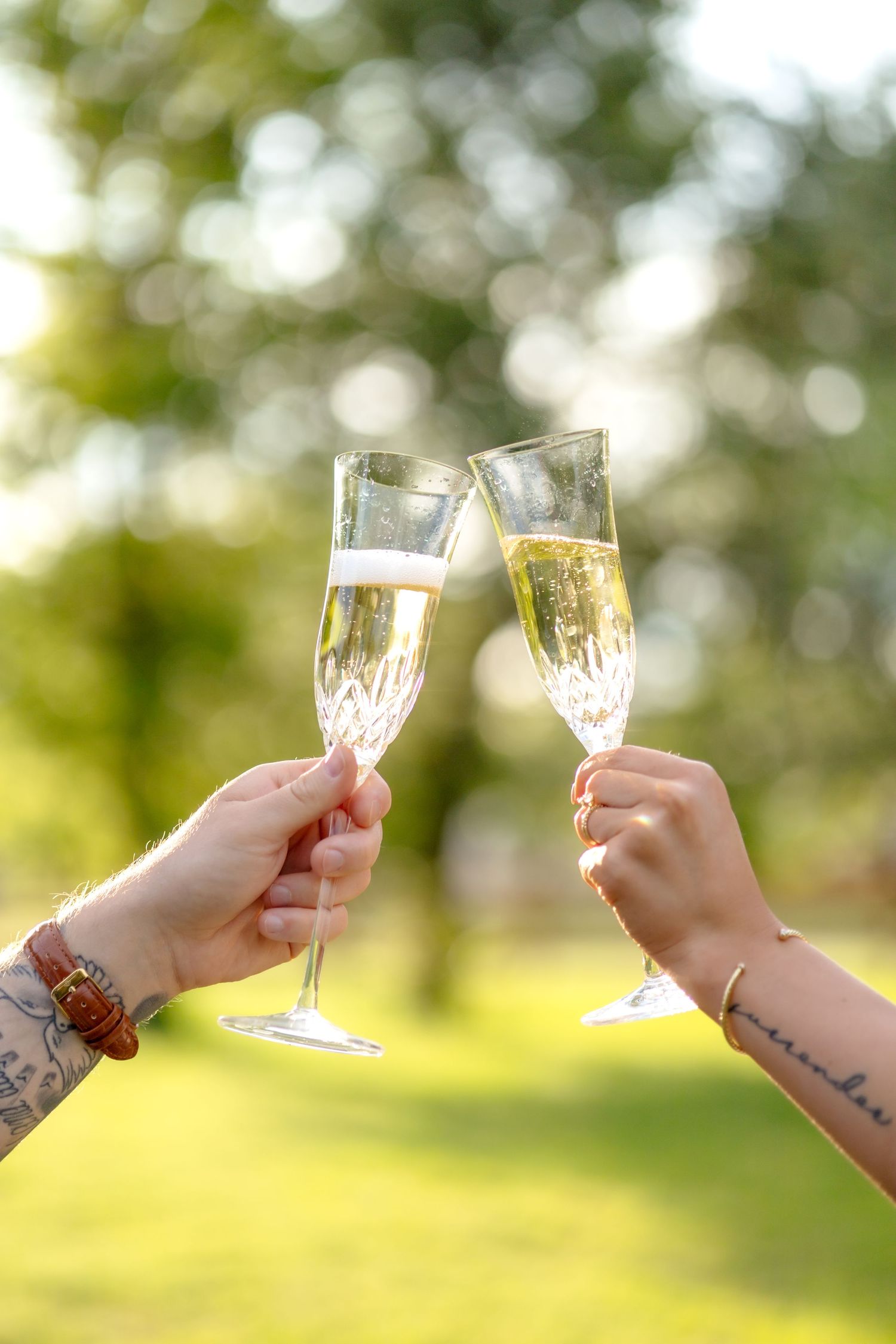 Husband and wife clinking their glasses of champagne at the end of a couple's photo session in Abilene, TX