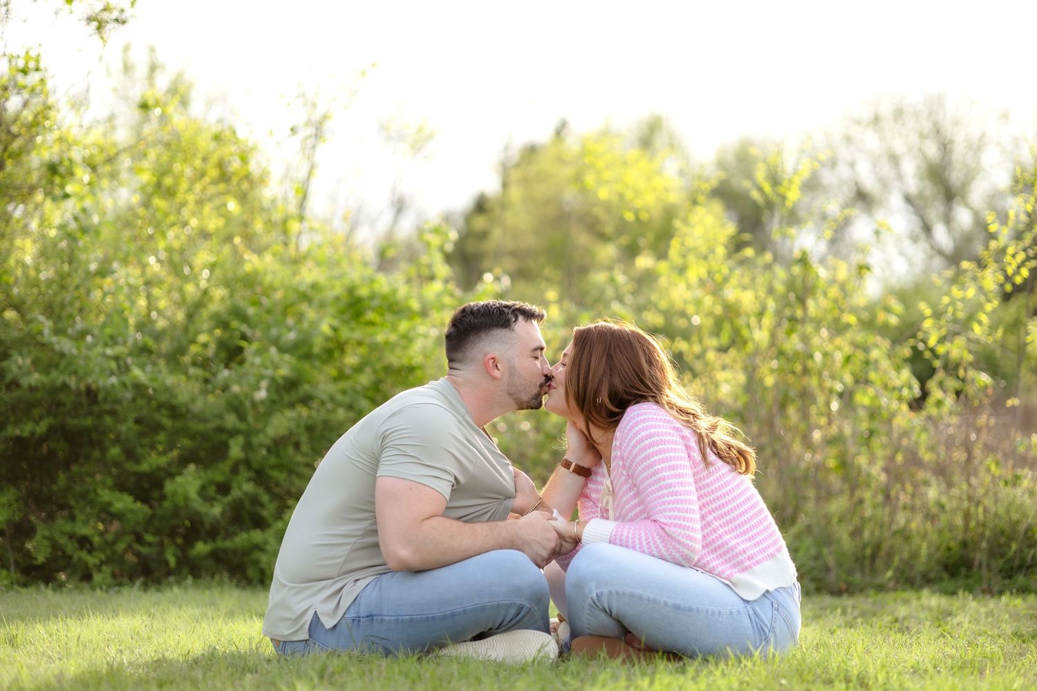 Married couple sitting facing each other and sharing a romantic kiss in Dallas