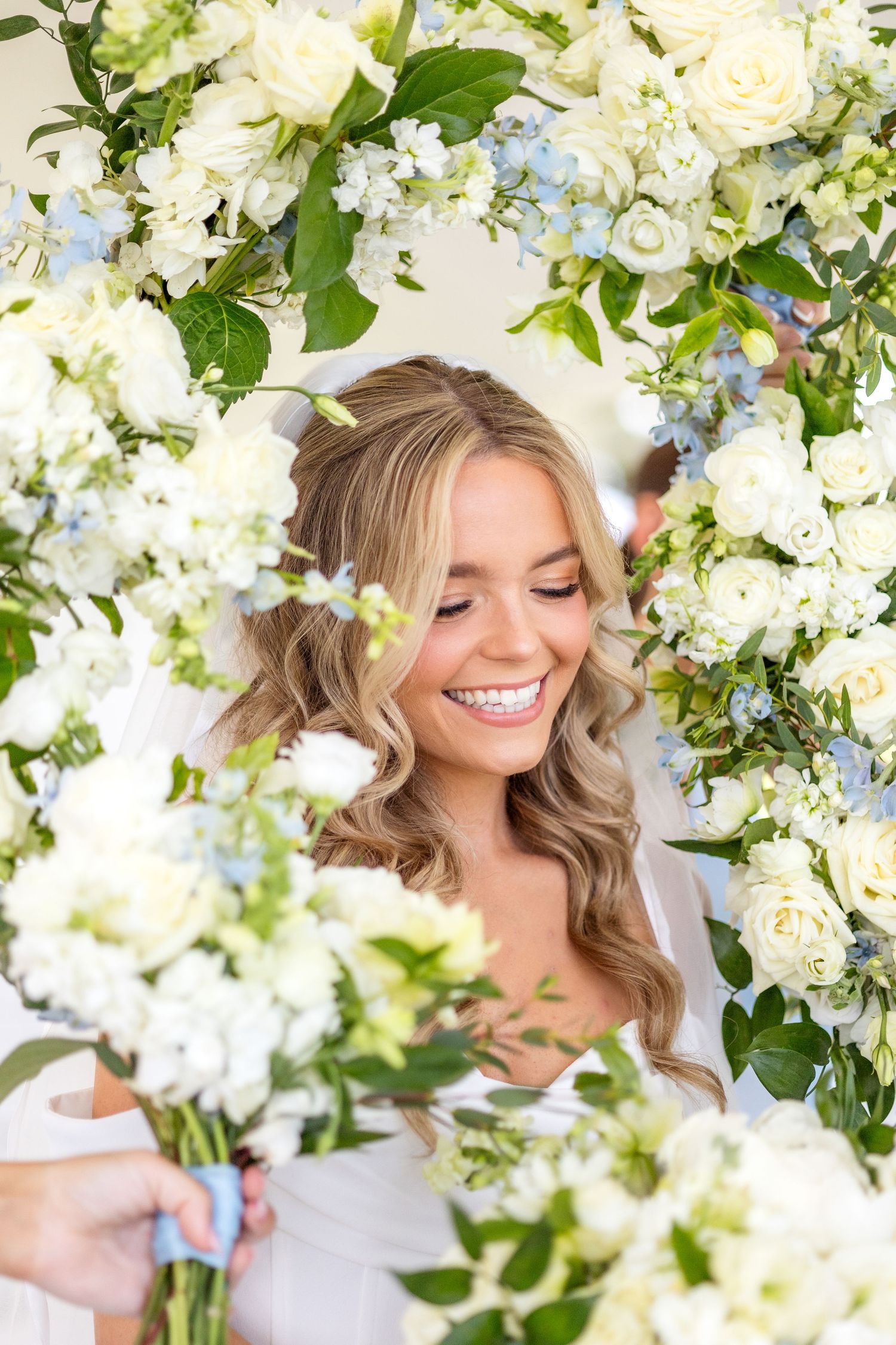 Spring wedding flower bouquets in a circle around the bride's face to create a flower frame
