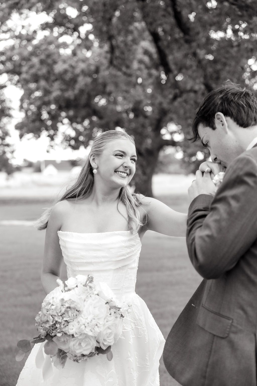 Groom kissing bride's hand at Dallas wedding