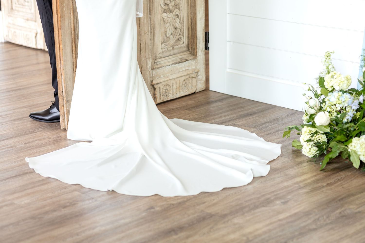 Detail image of bride's dress during private vows and first touch