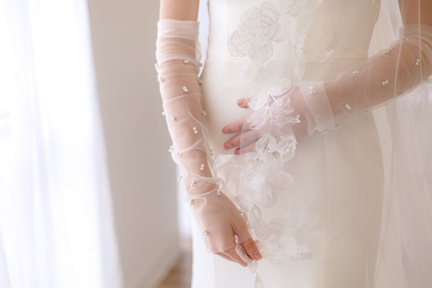 Details of a clean slim wedding dress with beautiful lace veil and pearl sleeves in Dallas, Texas. Wedding Photographer