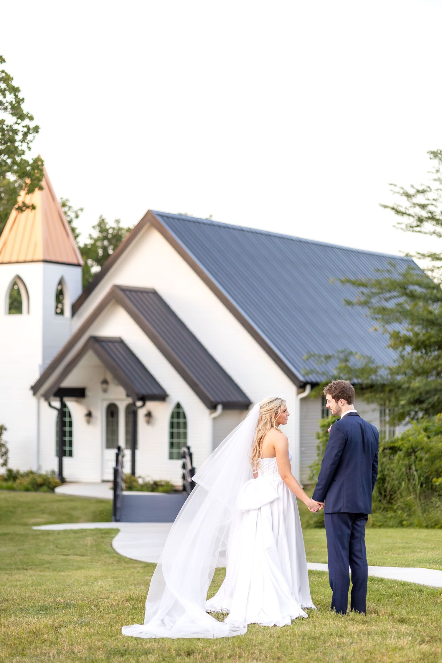 Bride and groom holding hands in front of a wedding chapel in Dallas, Texas