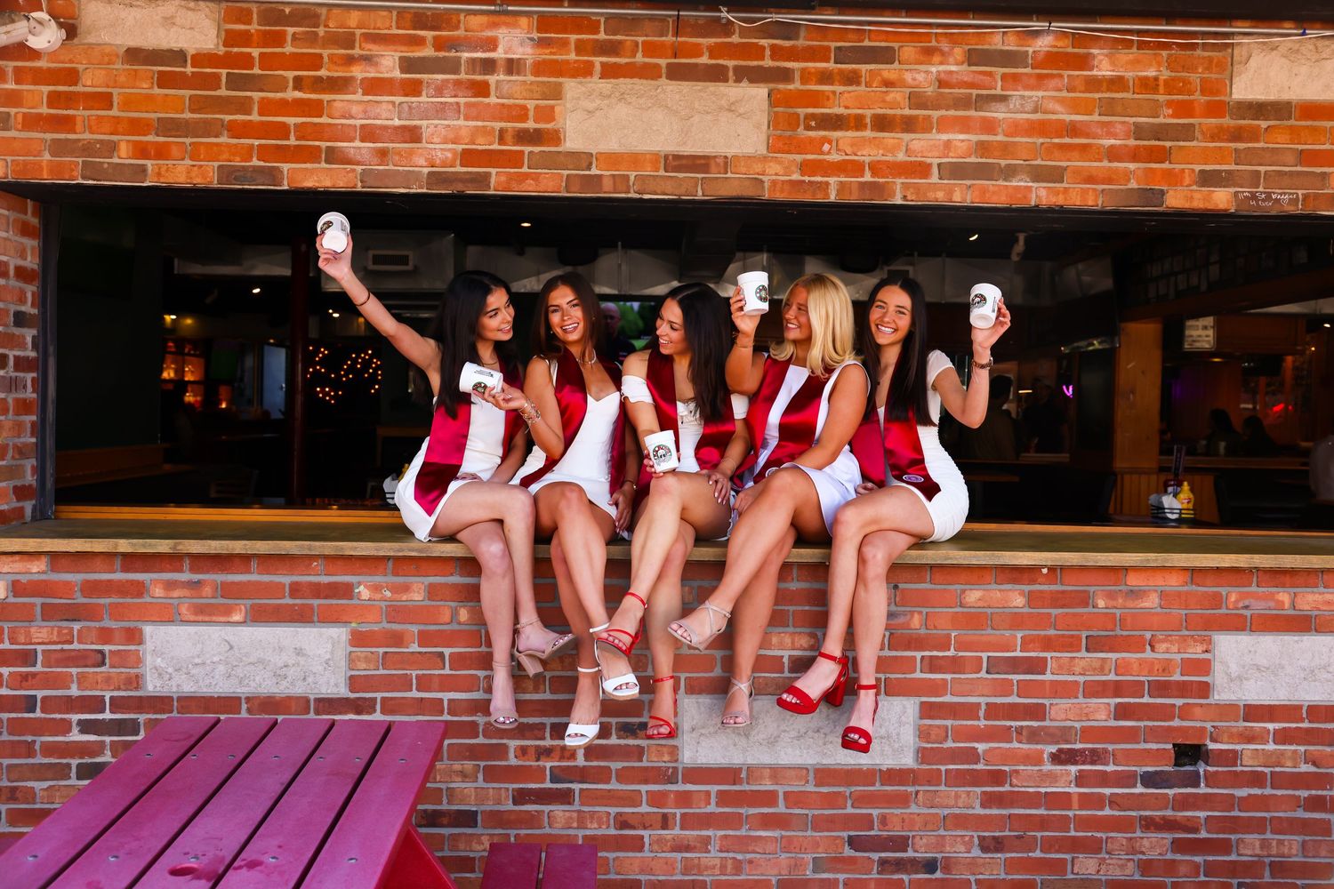 5 graduating women from Indiana university sitting on Kilroys bar