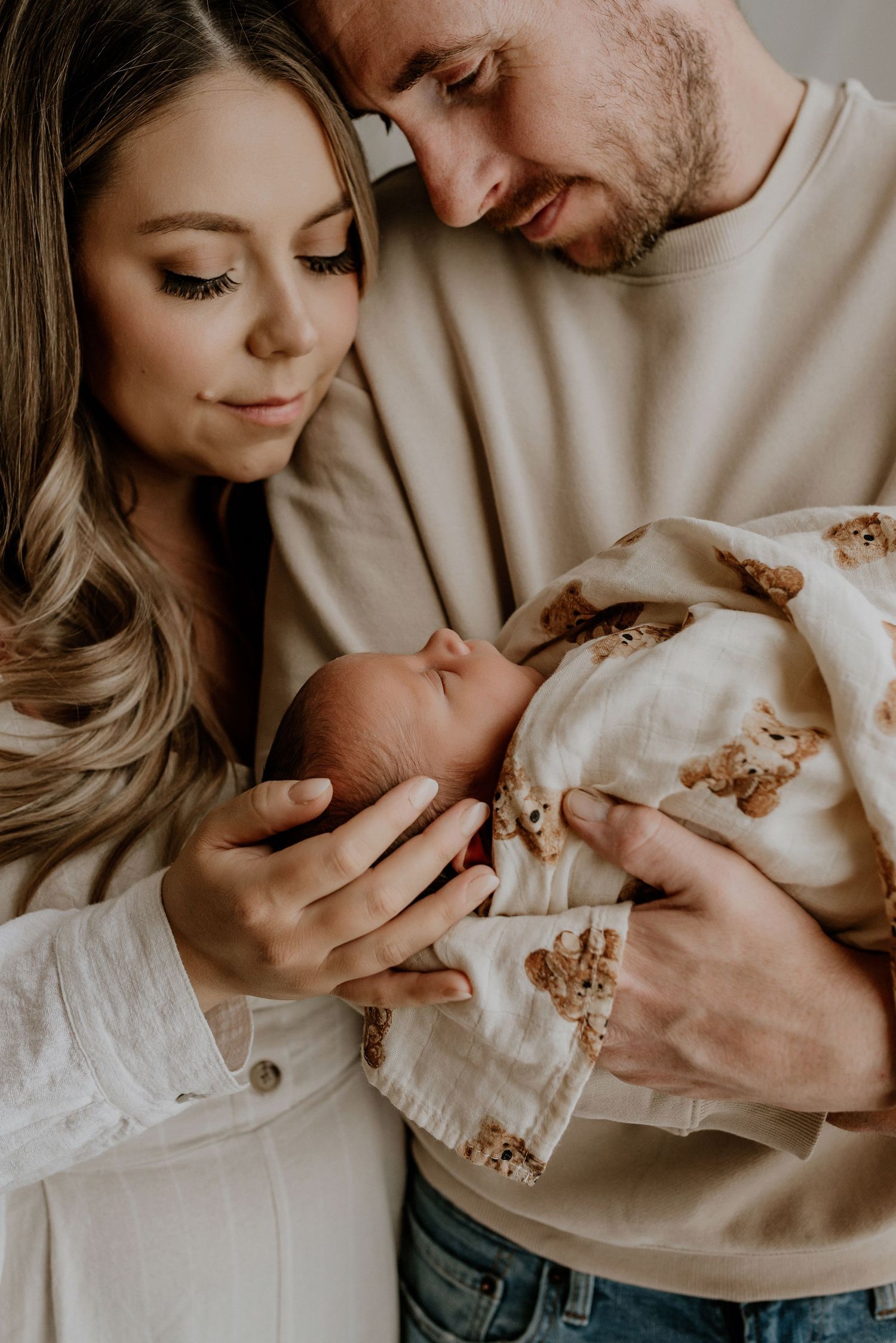 Heart and Gable newborn photography of baby wrapped in soft blanket, highlighting delicate details and innocence.
