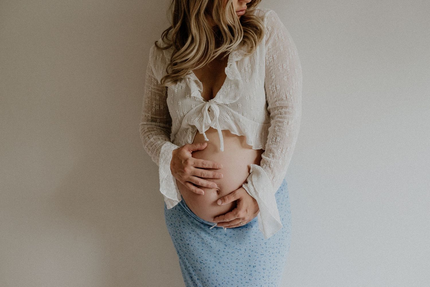 Studio maternity portrait of expecting mother in Edmonton, Alberta, showcasing elegant and timeless pregnancy photos.