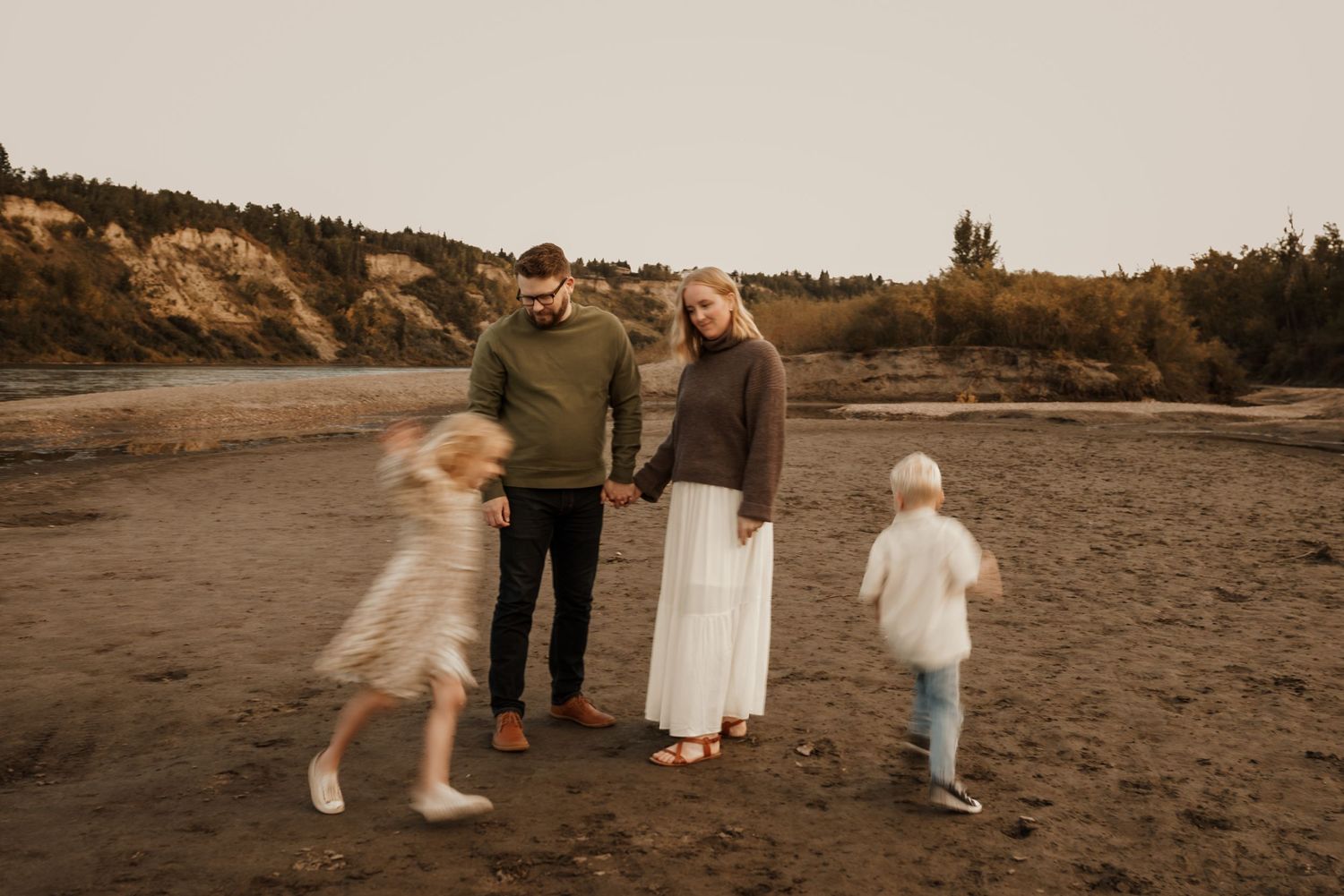 Edmonton family photo session with parents and children laughing, highlighting candid family photography style.