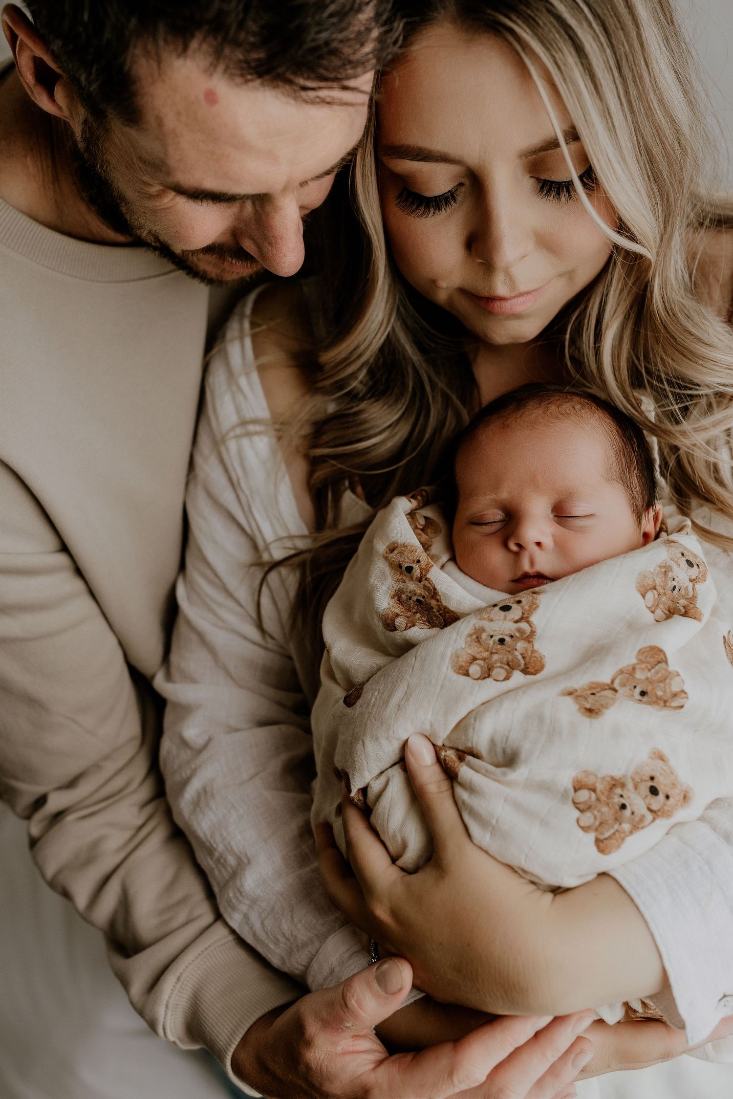 Heart and Gable newborn photography of baby wrapped in soft blanket, highlighting delicate details and innocence.