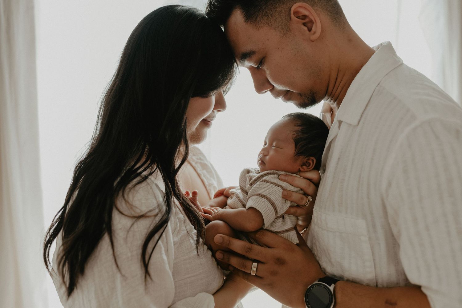 Adorable sleeping baby in cozy Edmonton studio setup, perfect example of newborn photography with soft lighting.