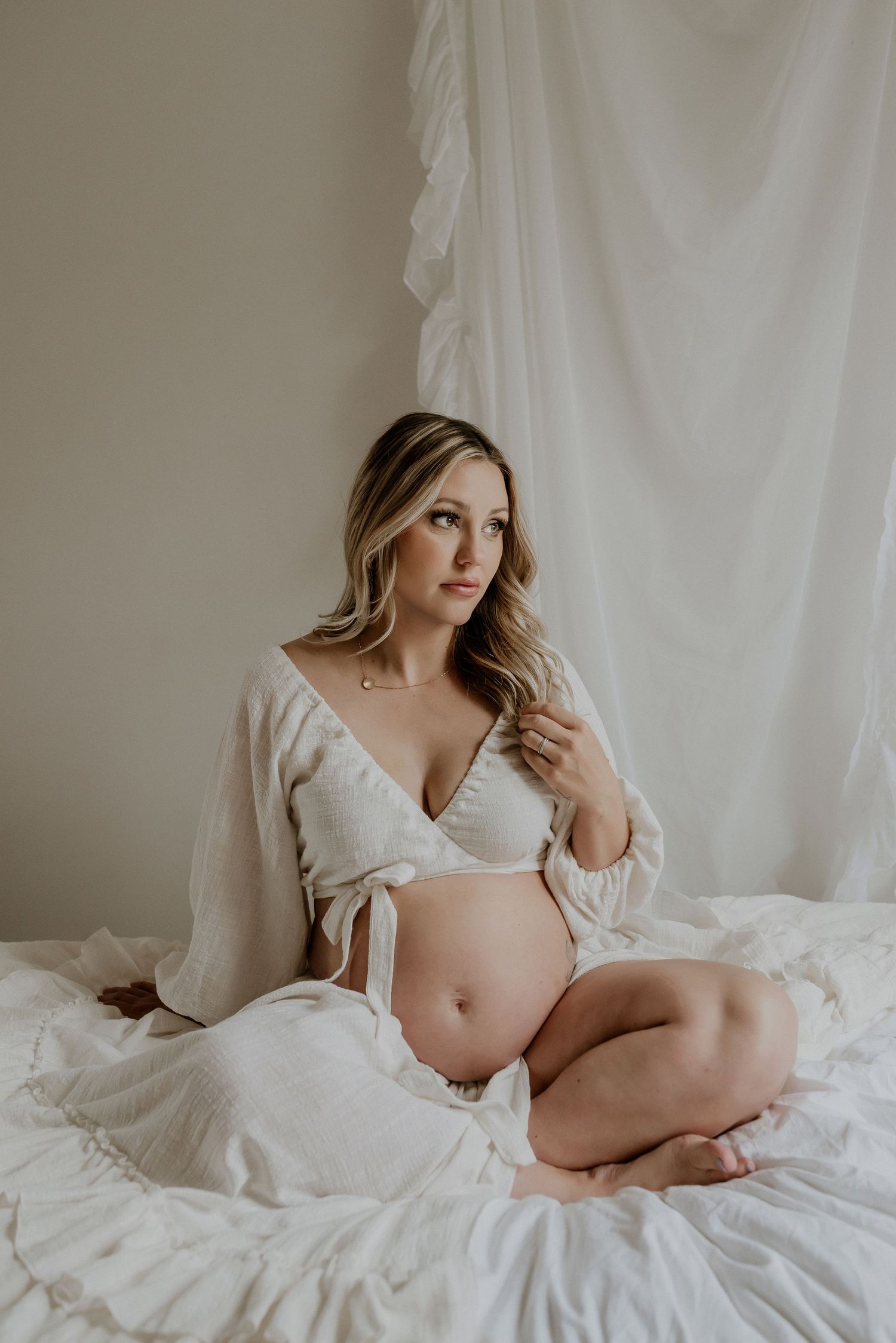 Studio maternity portrait of expecting mother in Edmonton, Alberta, showcasing elegant and timeless pregnancy photos.