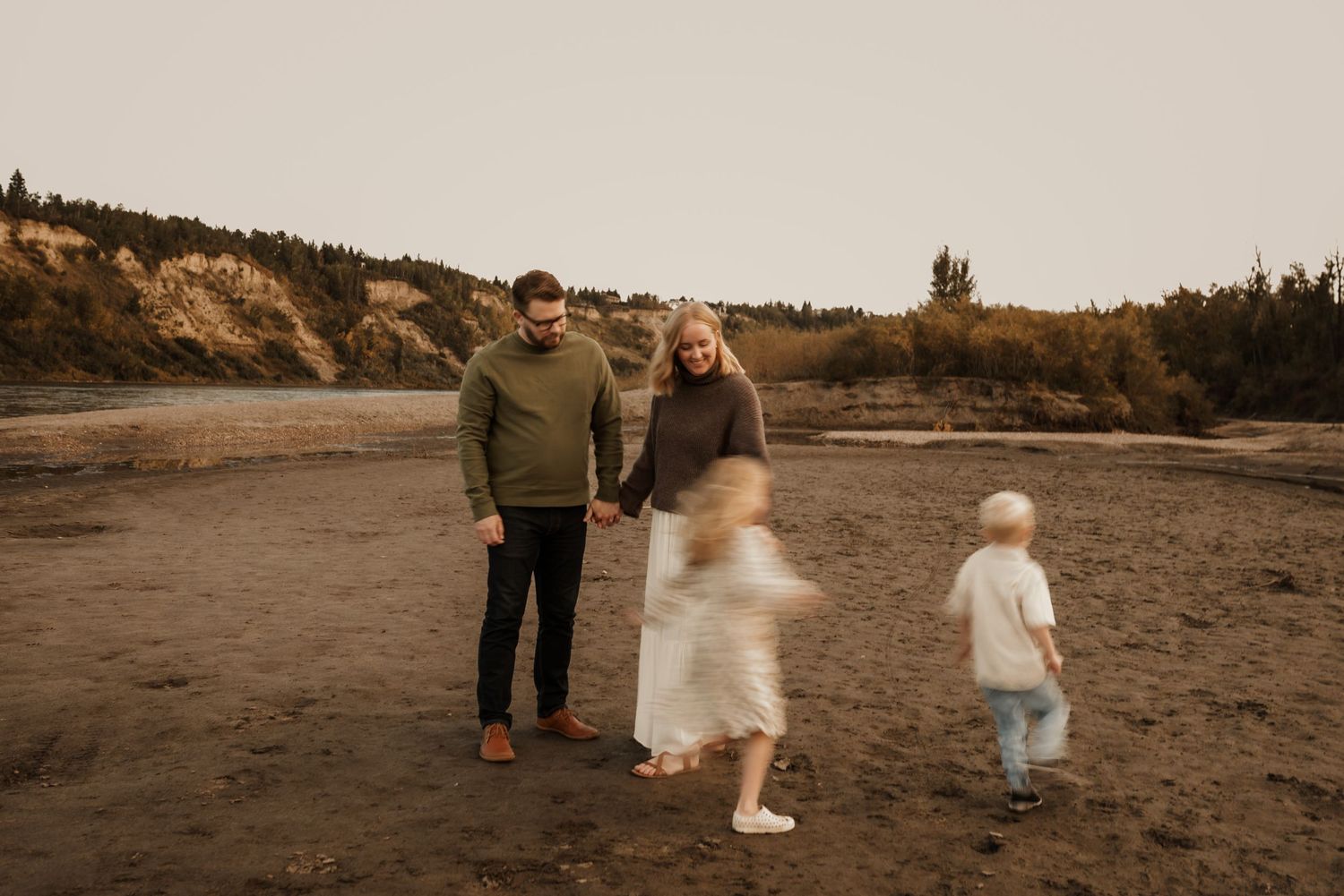 Family photography session in Edmonton, Alberta, capturing parents and children enjoying light-filled portraits.