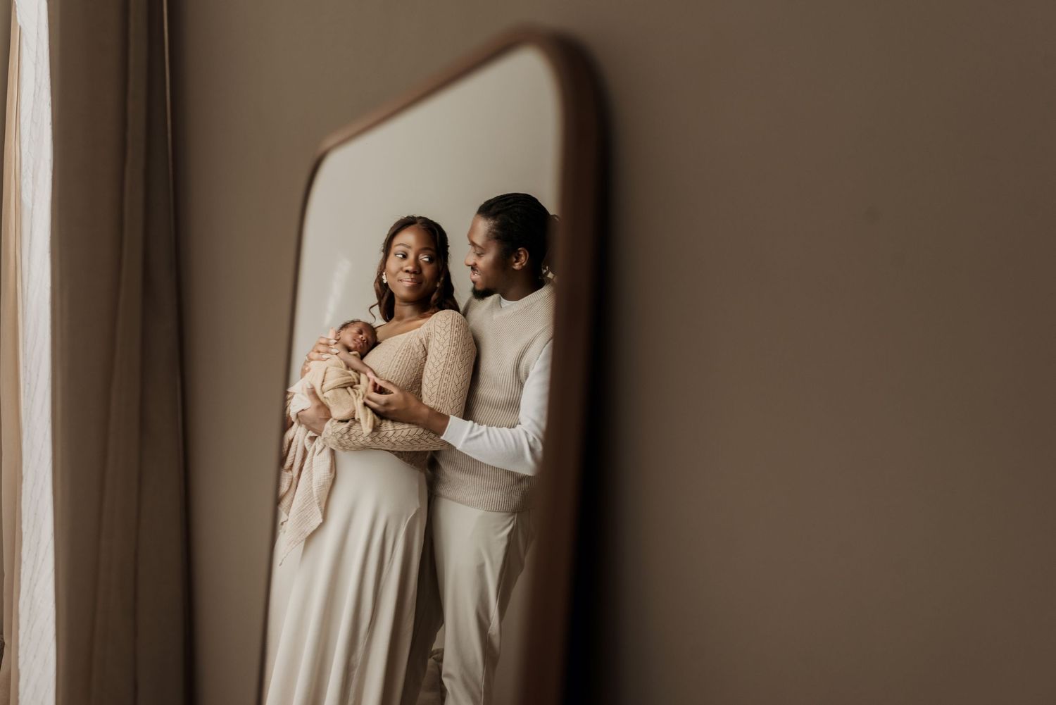 Family in studio photography session in Edmonton, Alberta, capturing peaceful early life moments.