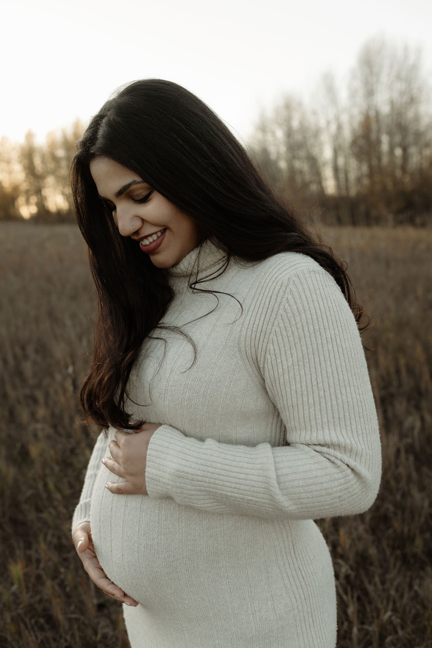 Outdoor maternity portrait of expecting mother in Edmonton, Alberta, showcasing elegant and timeless pregnancy photos.