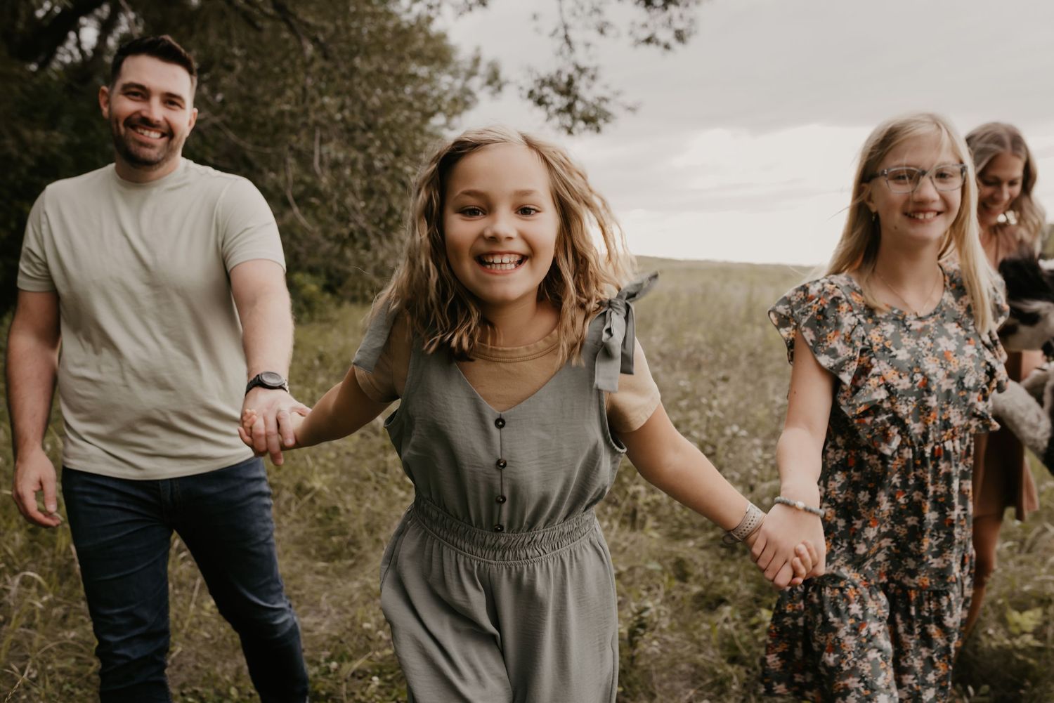 Family photography session in Edmonton, Alberta, capturing parents and children enjoying light-filled portraits.