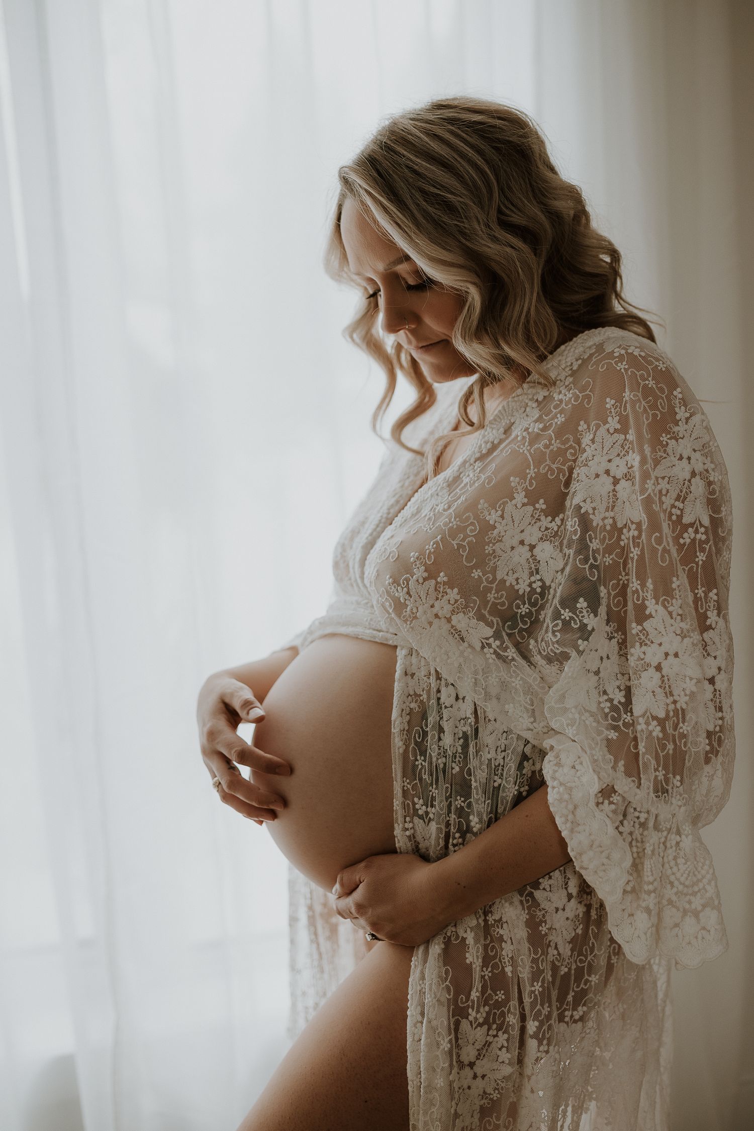 Studio maternity portrait of expecting mother in Edmonton, Alberta, showcasing elegant and timeless pregnancy photos.