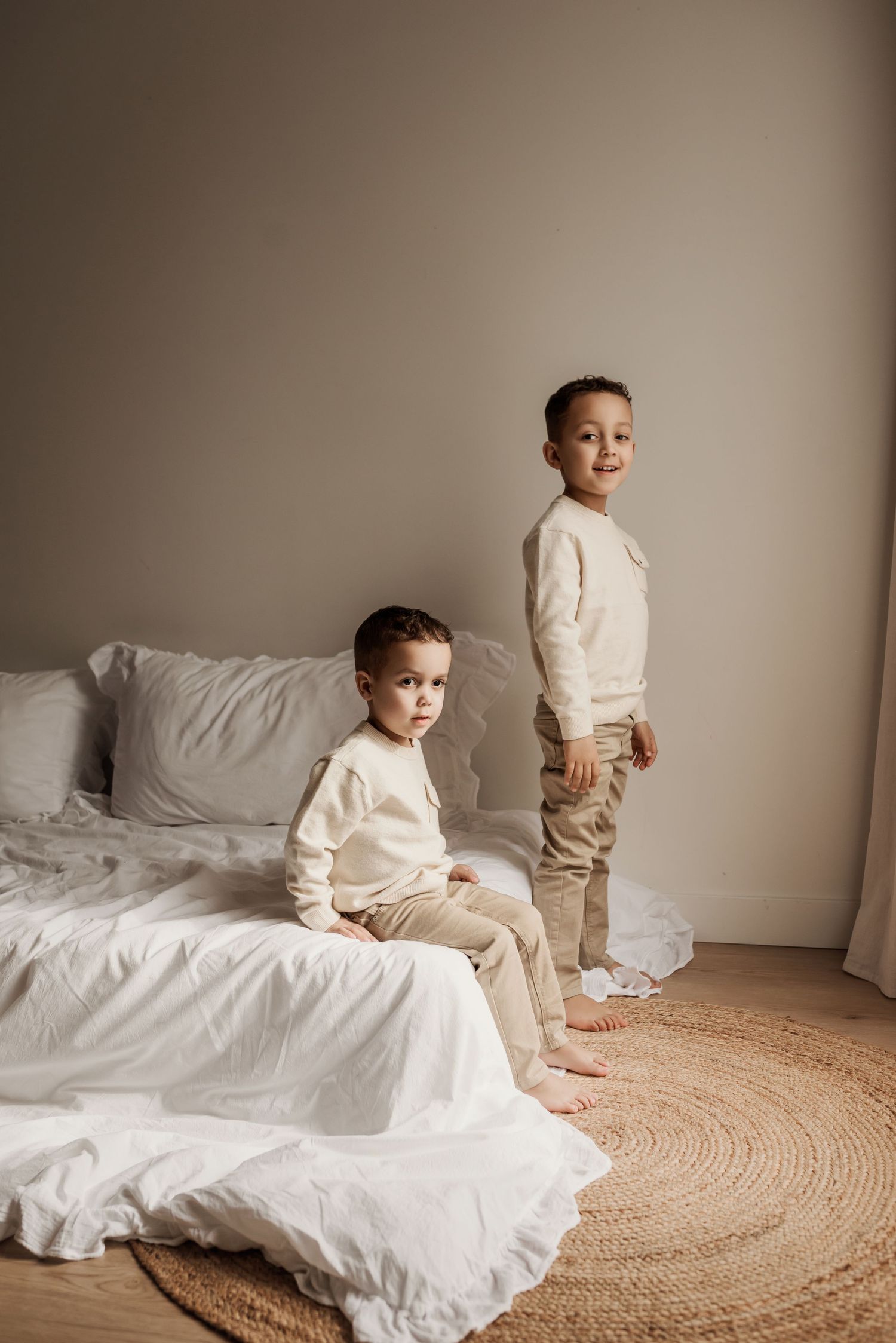 Family photography session in Edmonton, Alberta, capturing children enjoying light-filled portraits.