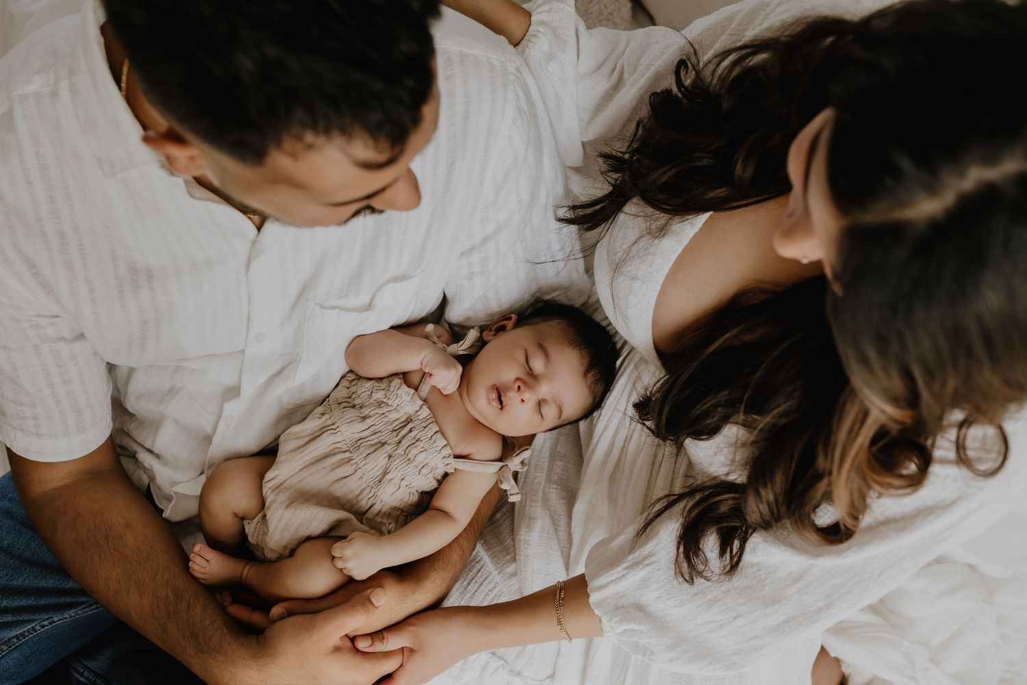 Adorable sleeping baby in cozy Edmonton studio setup, perfect example of newborn photography with soft lighting.