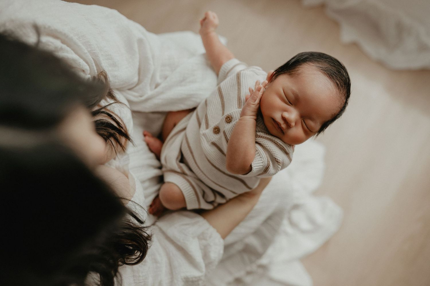 Sleeping newborn in studio photography session in Edmonton, Alberta, capturing peaceful early life moments.