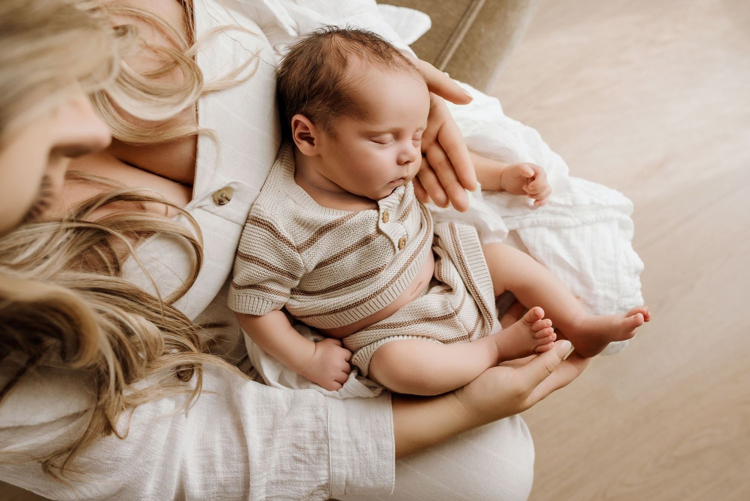 Close-up of newborn hands and feet in Edmonton studio, showcasing professional newborn photography style.