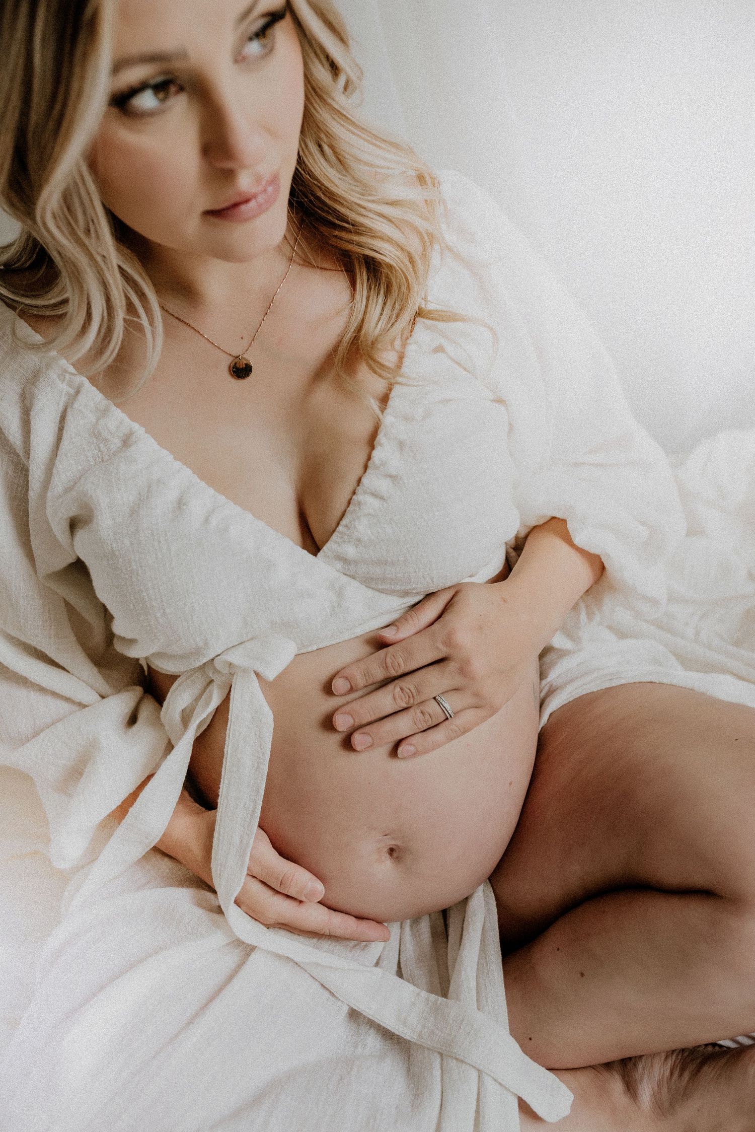 Studio maternity portrait of expecting mother in Edmonton, Alberta, showcasing elegant and timeless pregnancy photos.