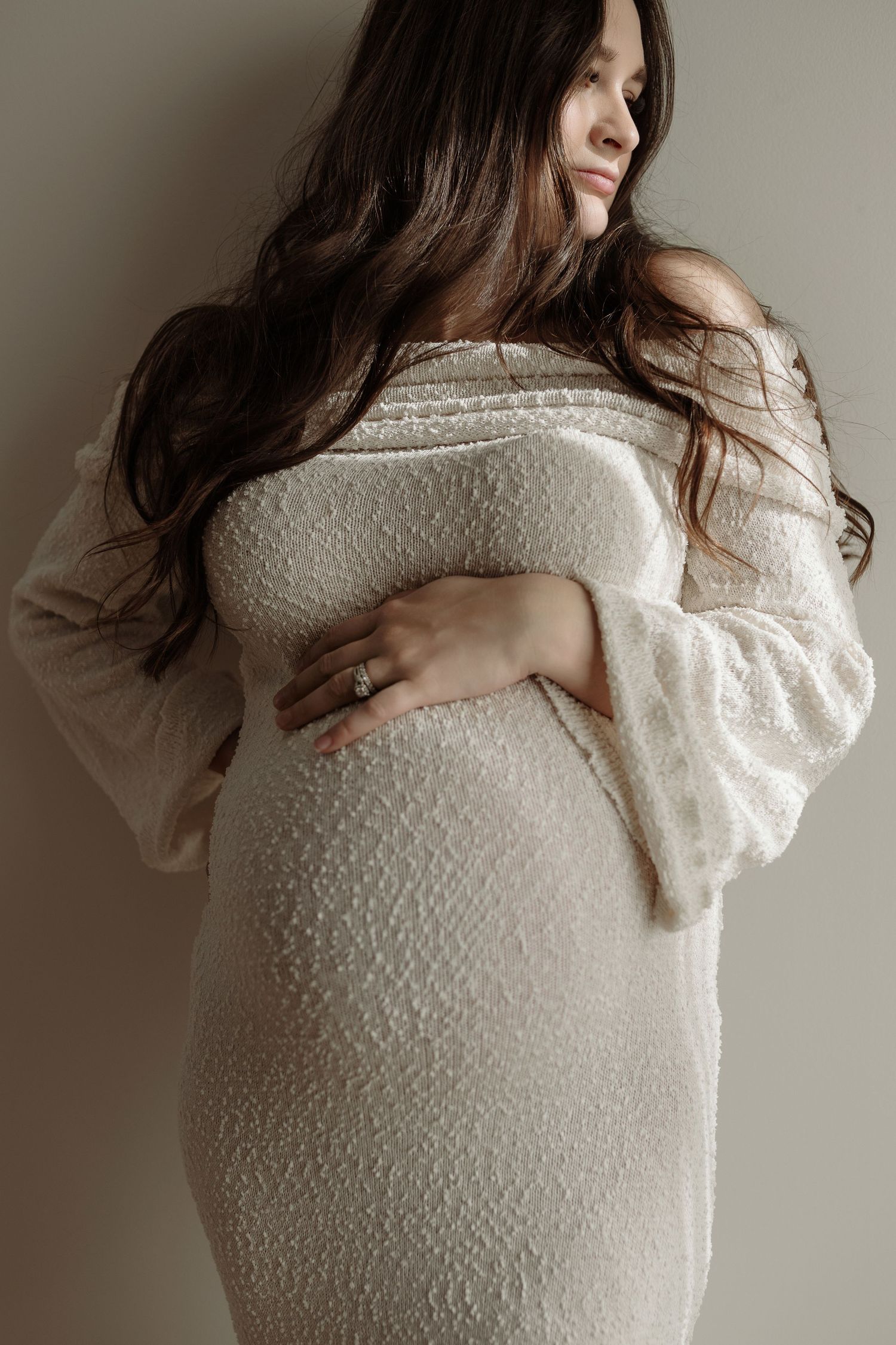 Studio maternity portrait of expecting mother in Edmonton, Alberta, showcasing elegant and timeless pregnancy photos.