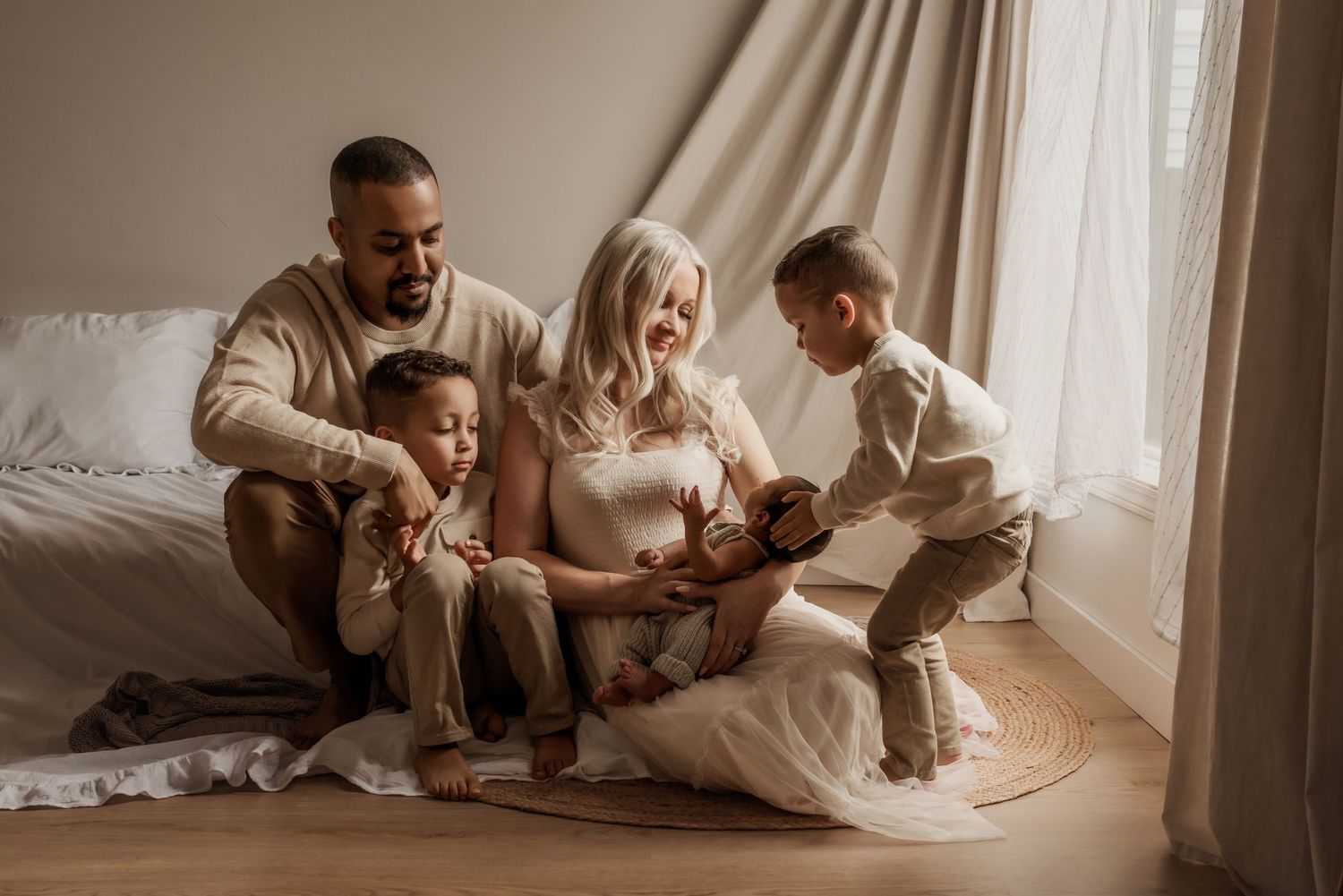 Family in studio photography session in Edmonton, Alberta, capturing peaceful early life moments.