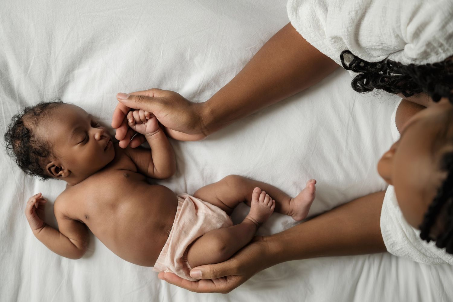 Close-up of newborn hands and feet in Edmonton studio, showcasing professional newborn photography style.