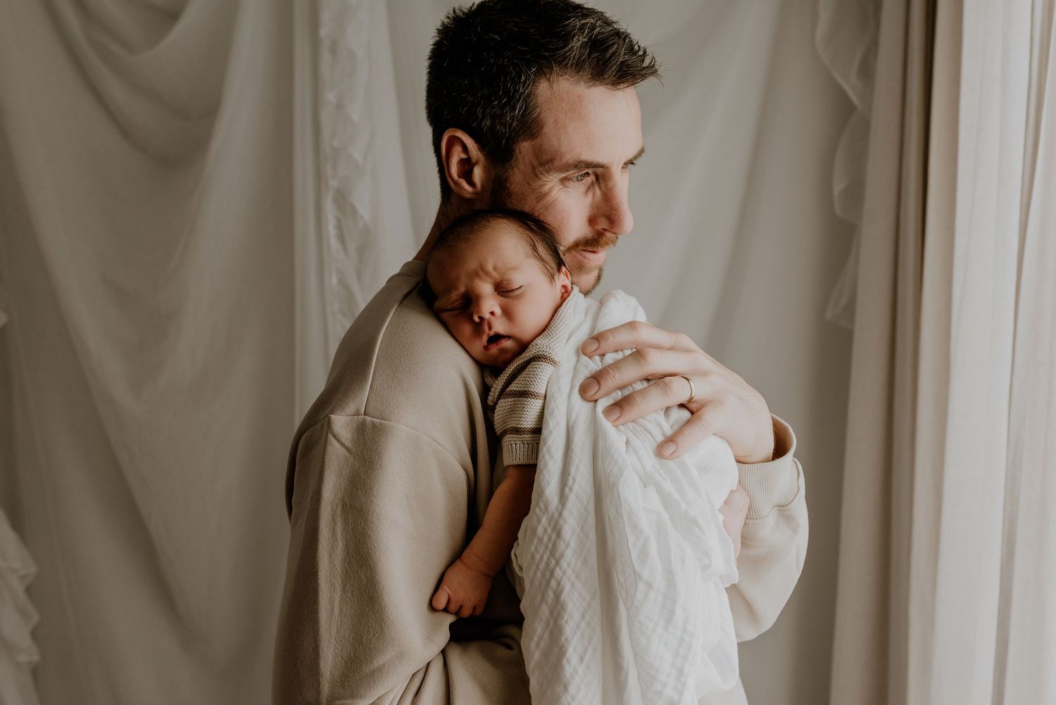 Close-up of newborn hands and feet in Edmonton studio, showcasing professional newborn photography style.
