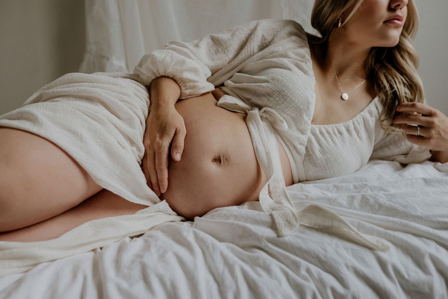 Studio maternity portrait of expecting mother in Edmonton, Alberta, showcasing elegant and timeless pregnancy photos.
