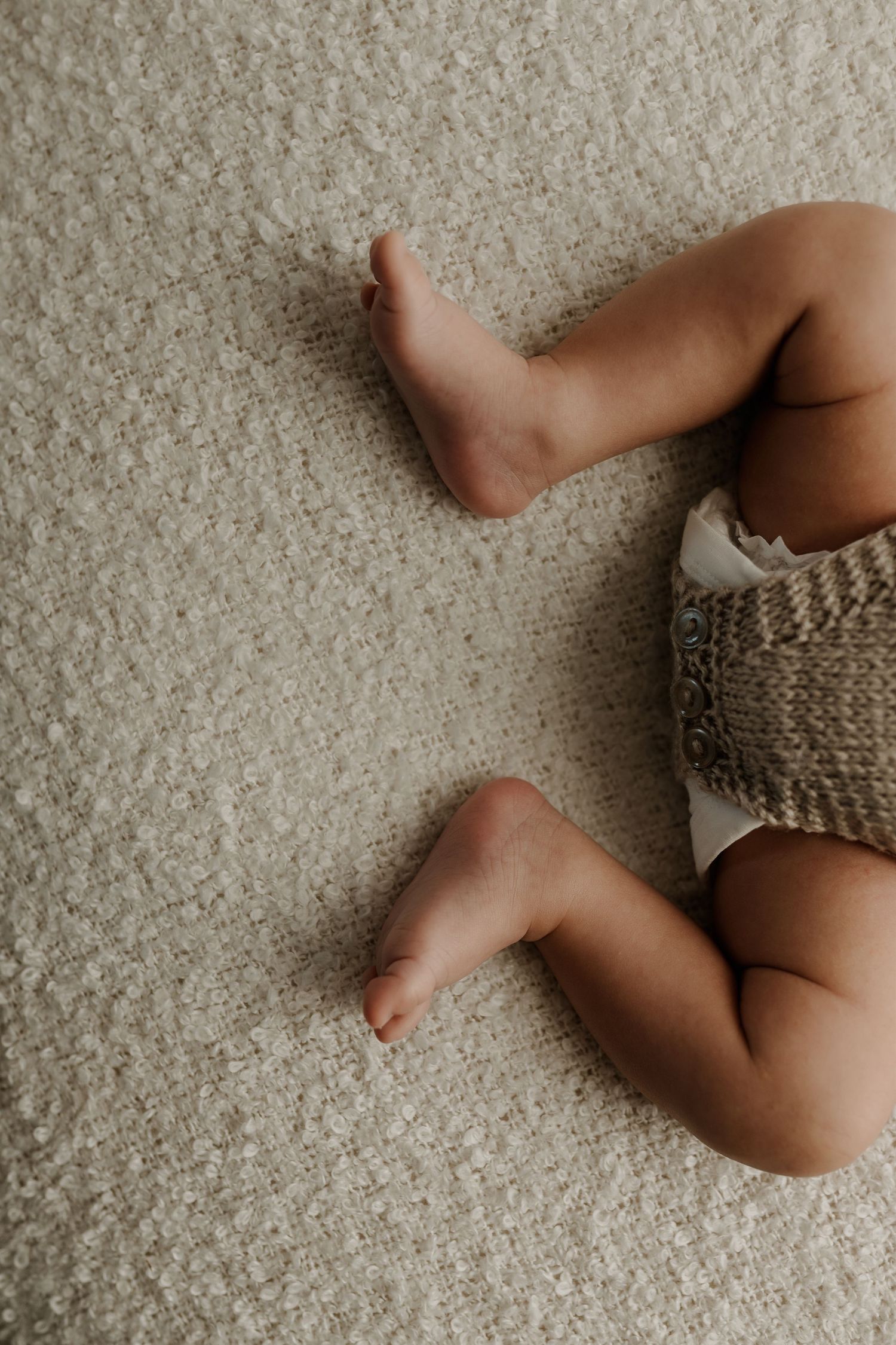 Close-up of newborn hands and feet in Edmonton studio, showcasing professional newborn photography style.