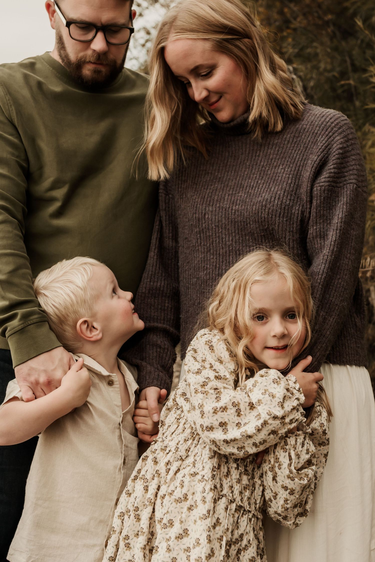 Edmonton family photo session with parents and children laughing, highlighting candid family photography style.