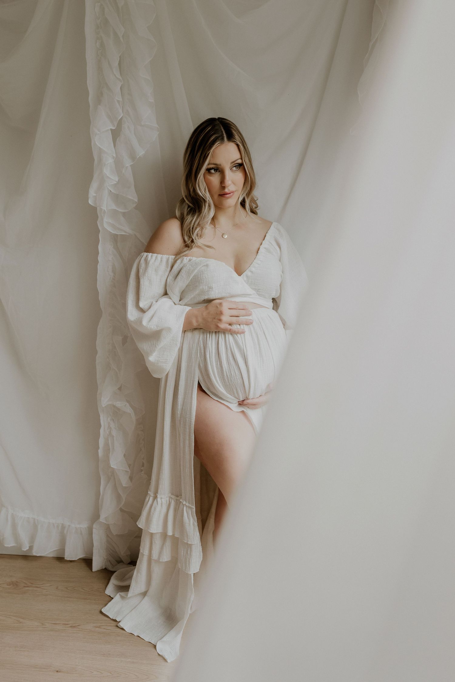 Studio maternity portrait of expecting mother in Edmonton, Alberta, showcasing elegant and timeless pregnancy photos.
