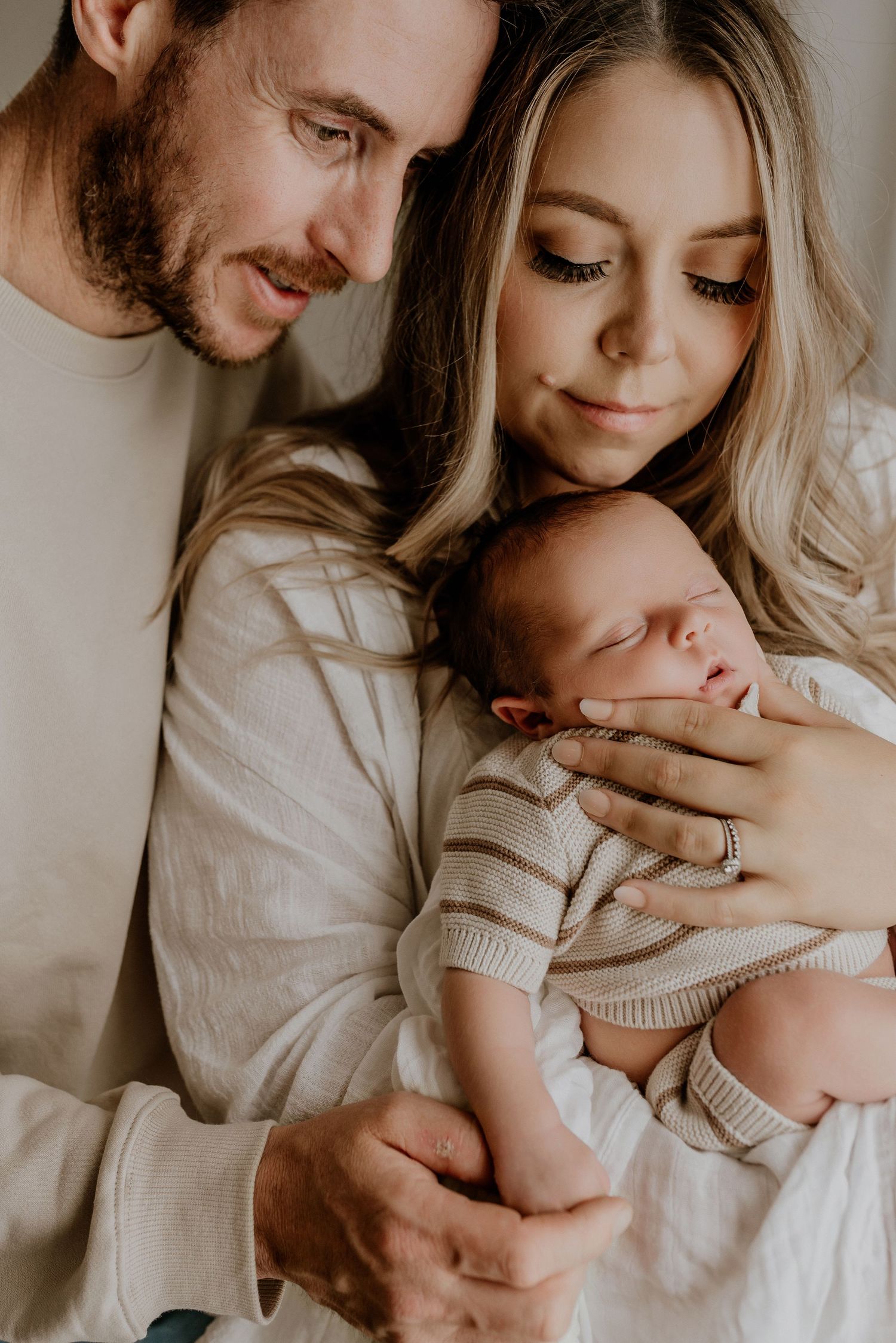 Close-up of newborn hands and feet in Edmonton studio, showcasing professional newborn photography style.